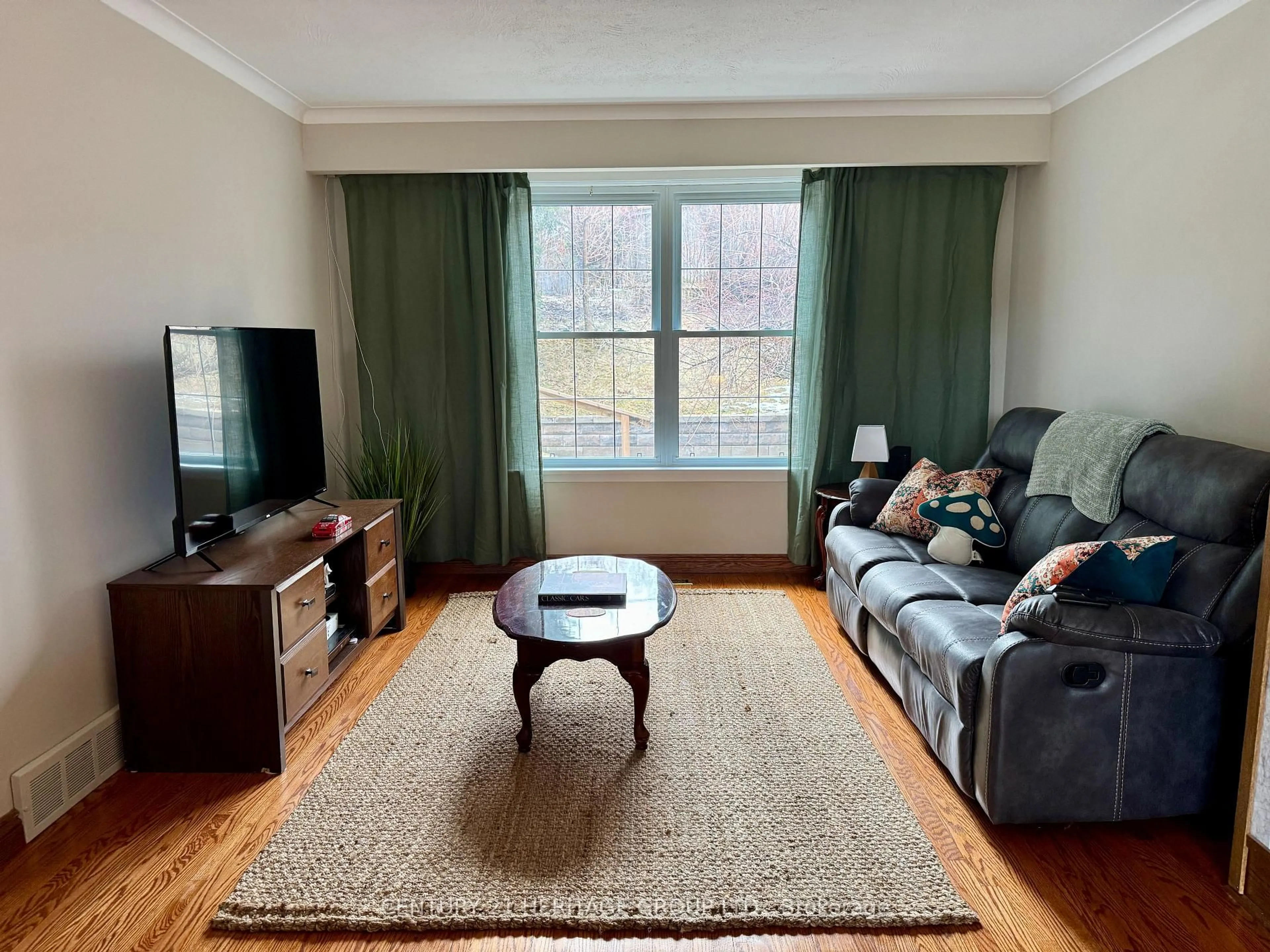 Living room with furniture, wood/laminate floor for 584 Arnhem Dr, Oshawa Ontario L1G 2J6