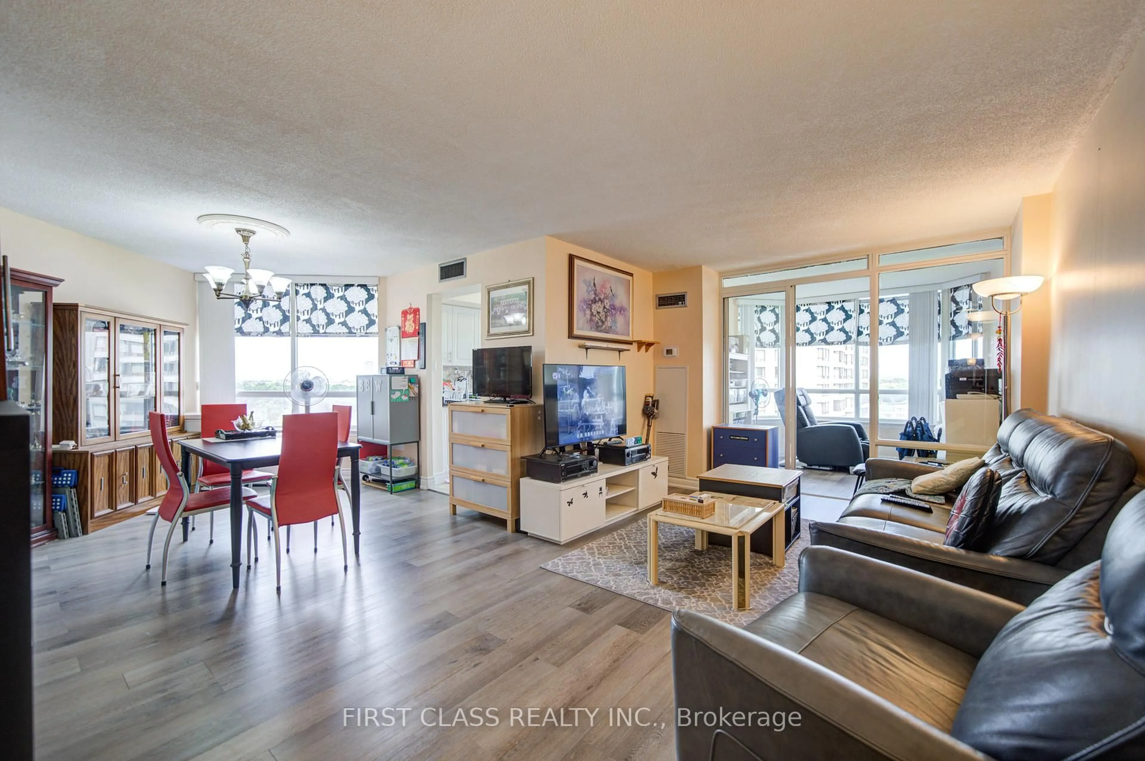 Living room with furniture, wood/laminate floor for 330 Alton Towers Circ #1112, Toronto Ontario M1V 5H3