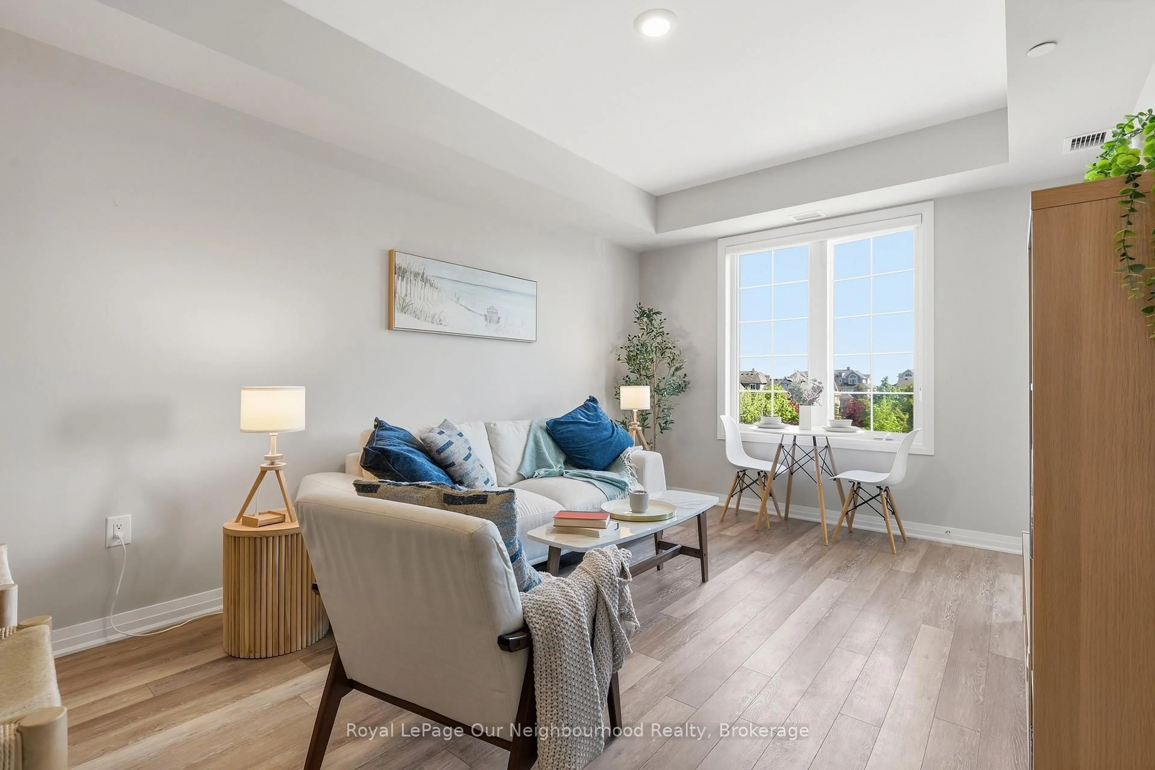 Living room with furniture, wood/laminate floor for 65 Shipway Ave #312, Clarington Ontario L1B 0B7