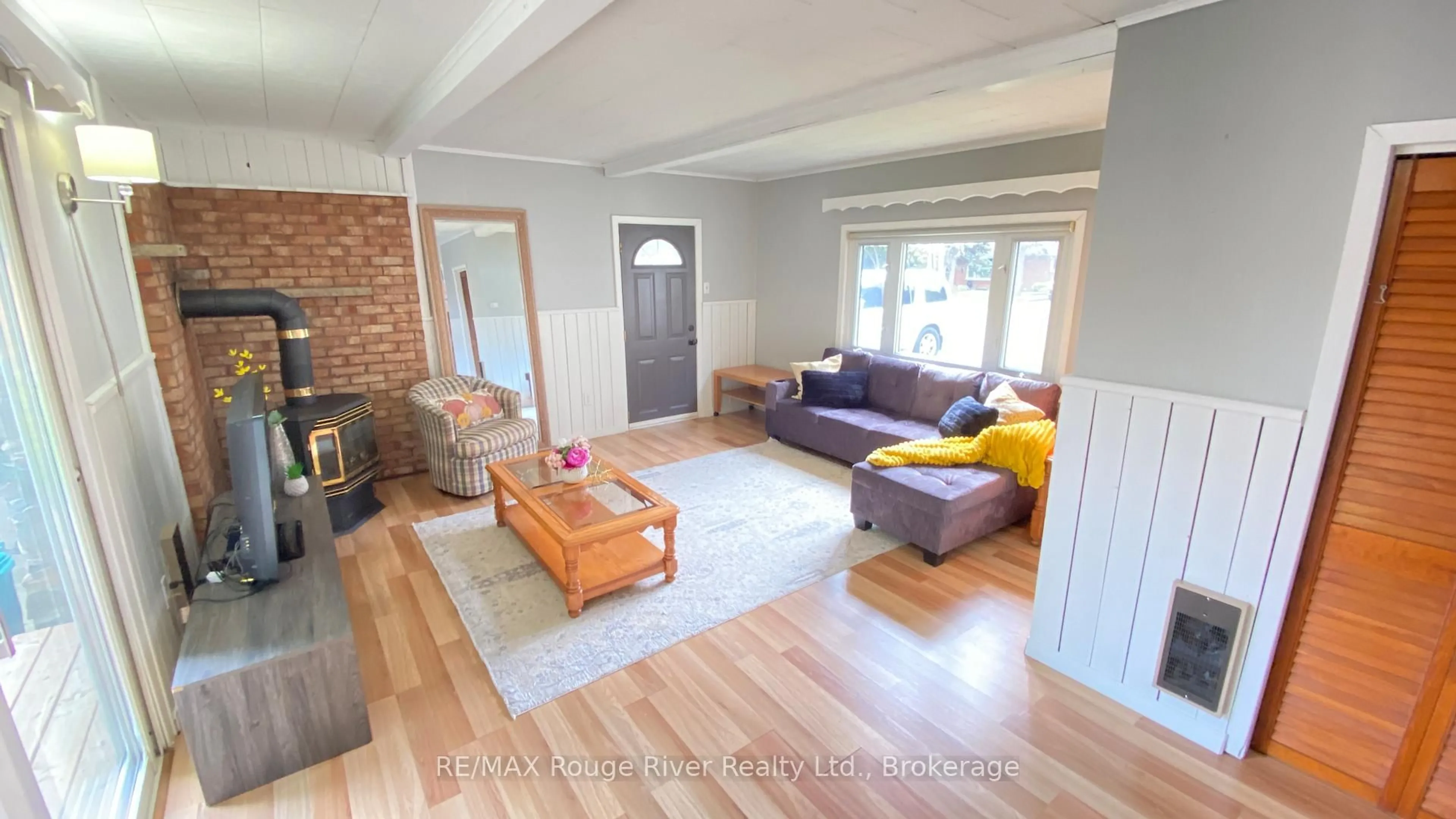 Living room with furniture, wood/laminate floor for 1329 Church St, Clarington Ontario L1B 1C6