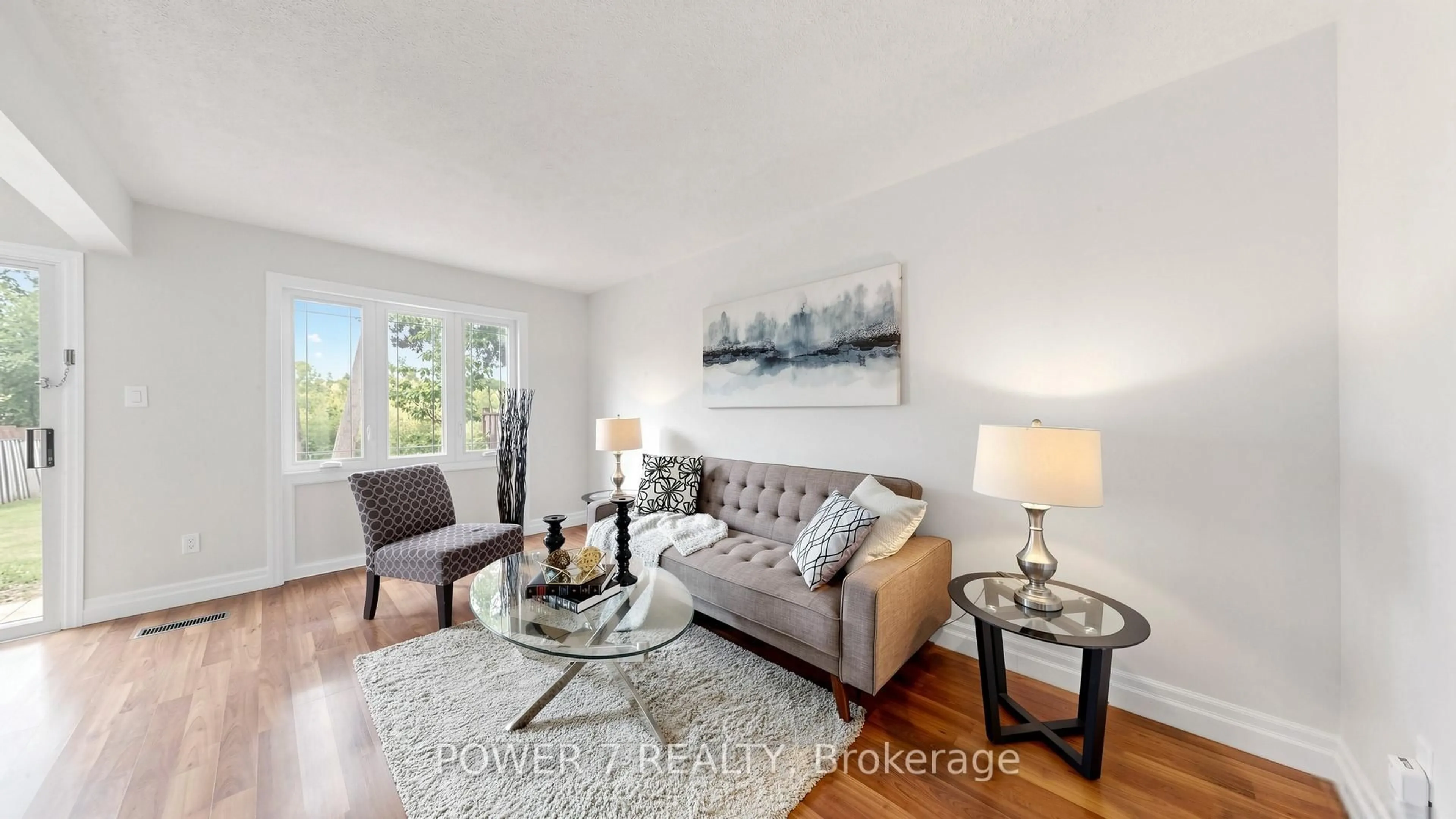 Living room with furniture, wood/laminate floor for 197 Bridletowne Circ #197, Toronto Ontario M1W 2H6
