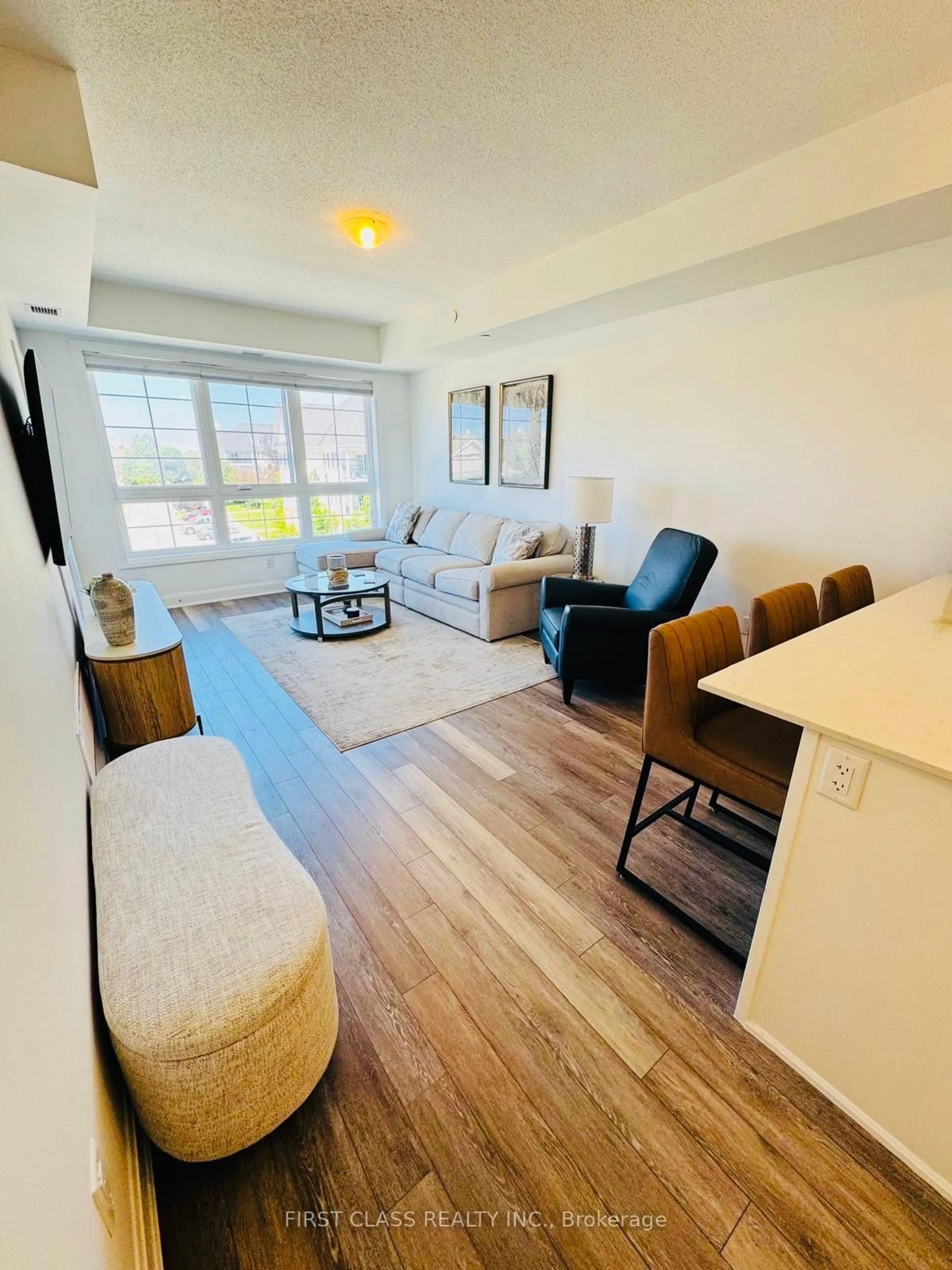 Living room with furniture, wood/laminate floor for 50 Lakebreeze Dr #306, Clarington Ontario L1B 0V9