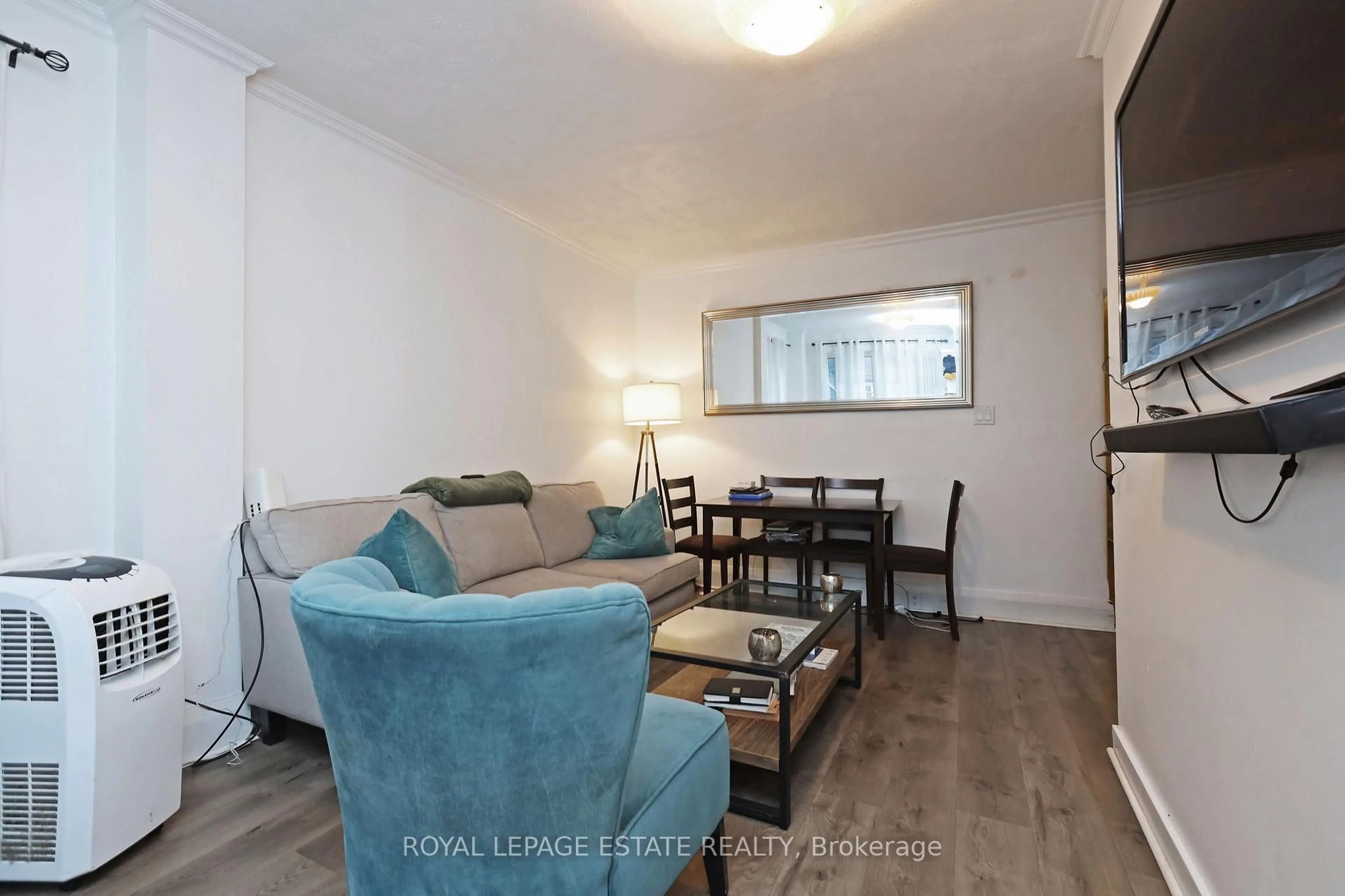 Living room with furniture, wood/laminate floor for 36 Meadow Ave, Toronto Ontario M1N 1V6