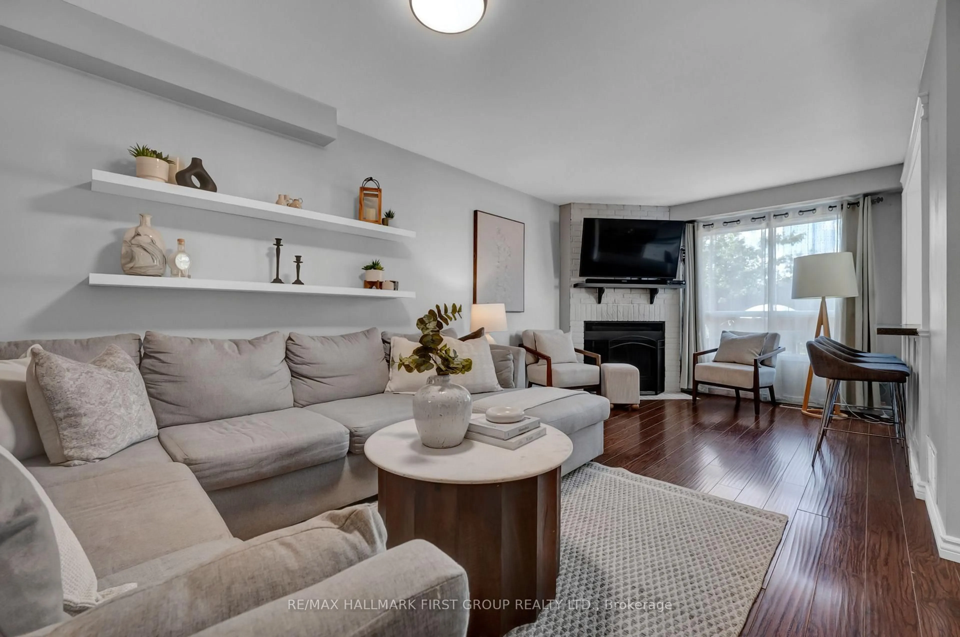 Living room with furniture, wood/laminate floor for 66 Windham Cres, Clarington Ontario L1E 1Y3