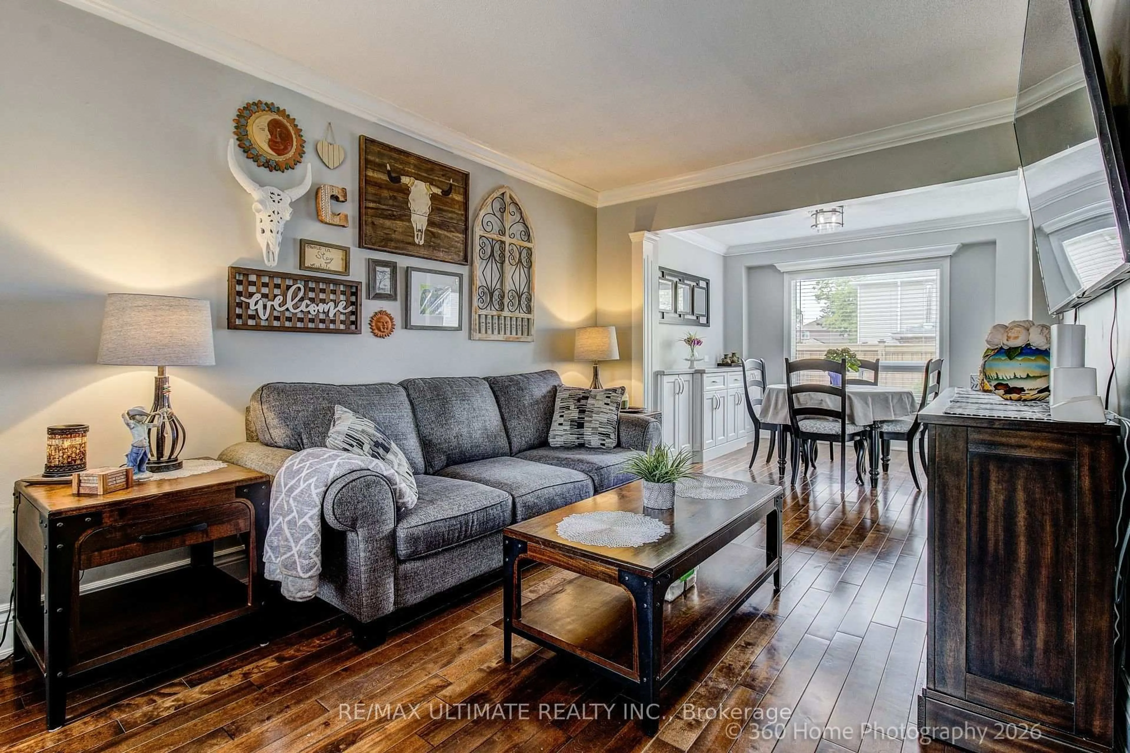 Living room with furniture, wood/laminate floor for 23 Windham Cres, Clarington Ontario L1E 1Y7