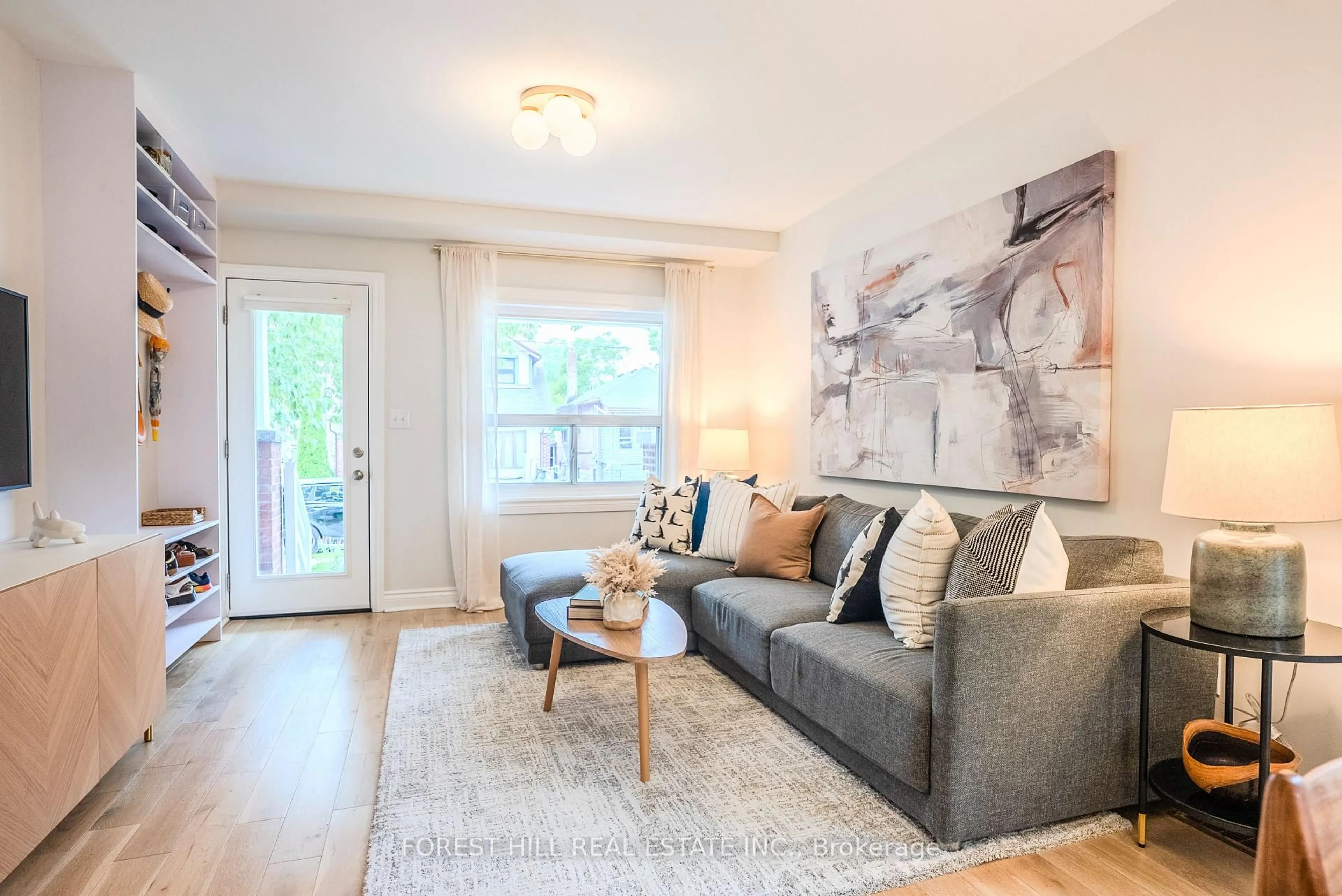 Living room with furniture, wood/laminate floor for 49 Gledhill Ave, Toronto Ontario M4C 5K7
