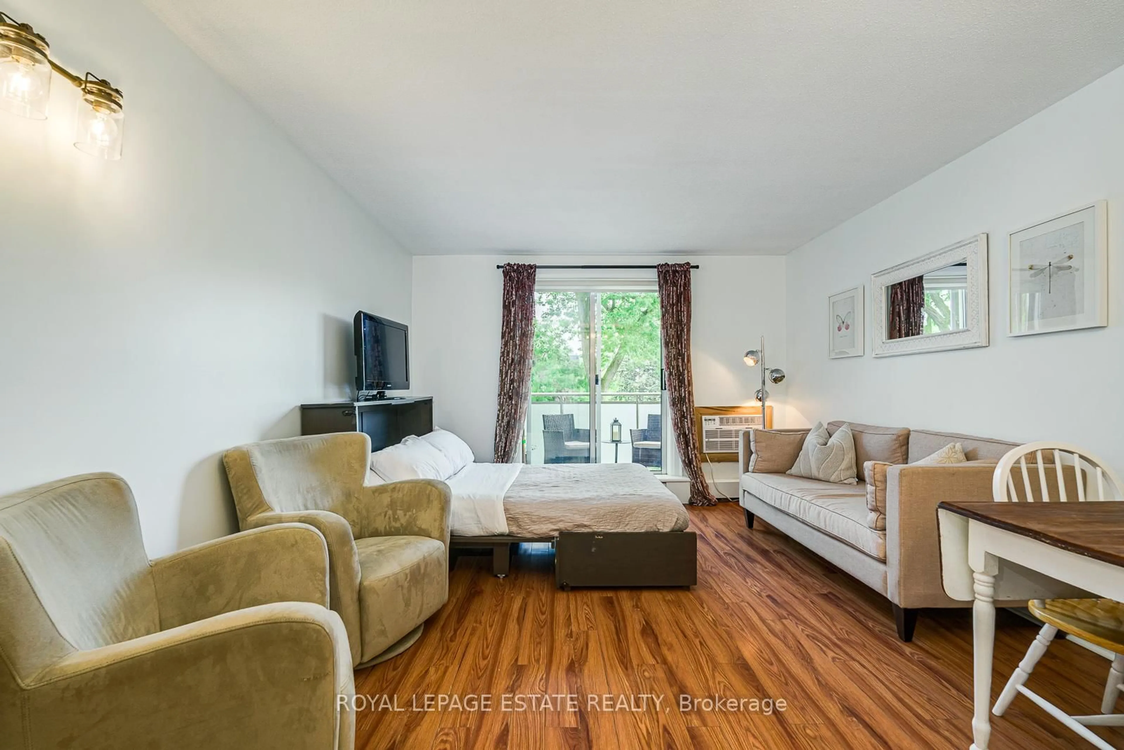 Living room with furniture, wood/laminate floor for 123 Woodbine Ave #309, Toronto Ontario M4L 3V8