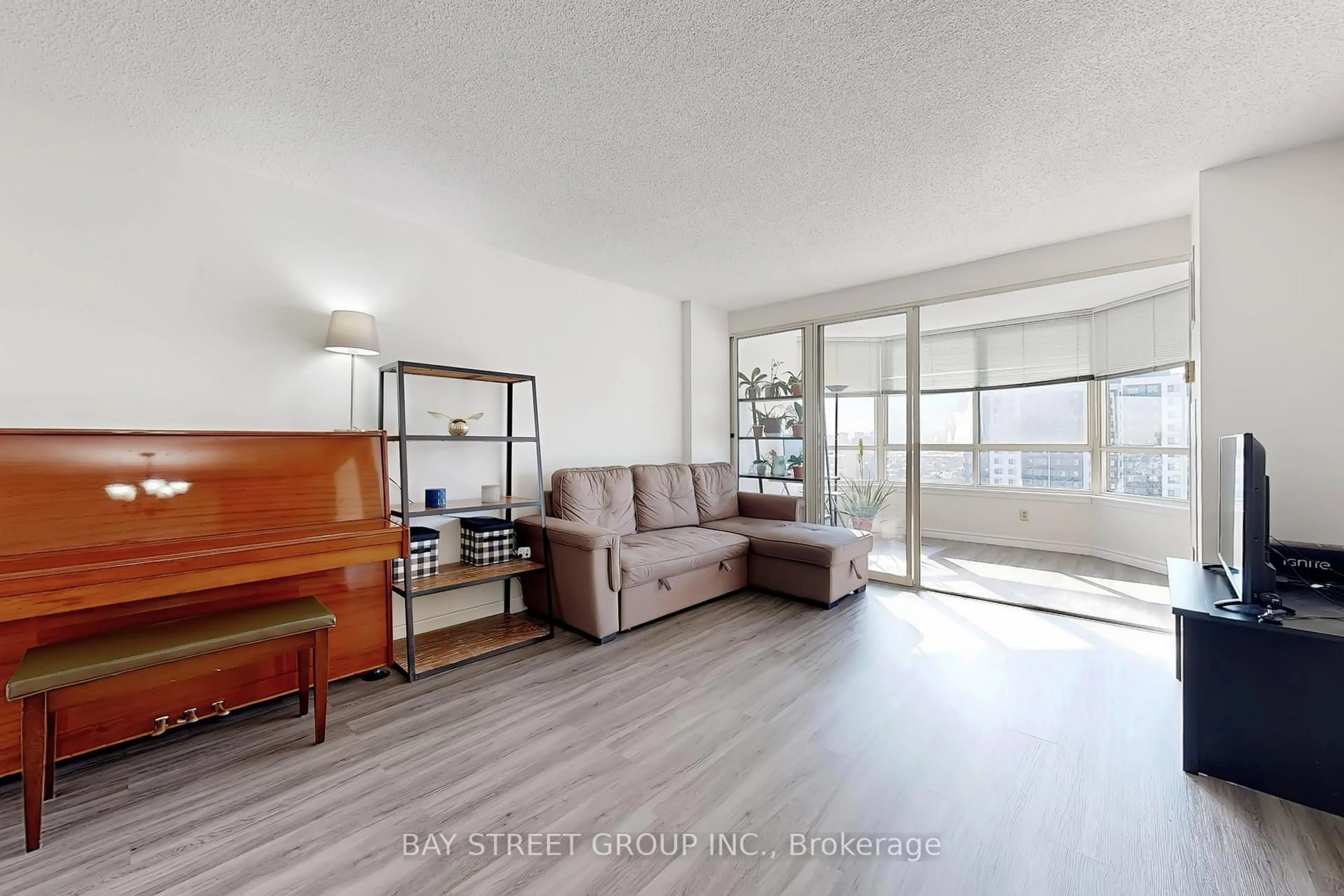 Living room with furniture, wood/laminate floor for 275 Bamburgh Circ #1708, Toronto Ontario M1W 3X4