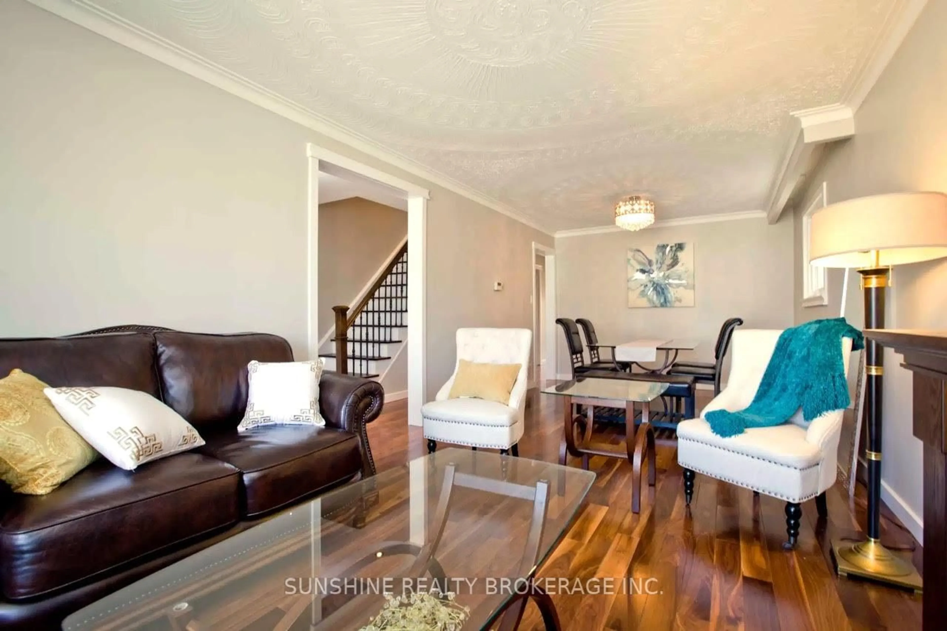 Living room with furniture, wood/laminate floor for 121 Sammon Ave, Toronto Ontario M4J 1Y9