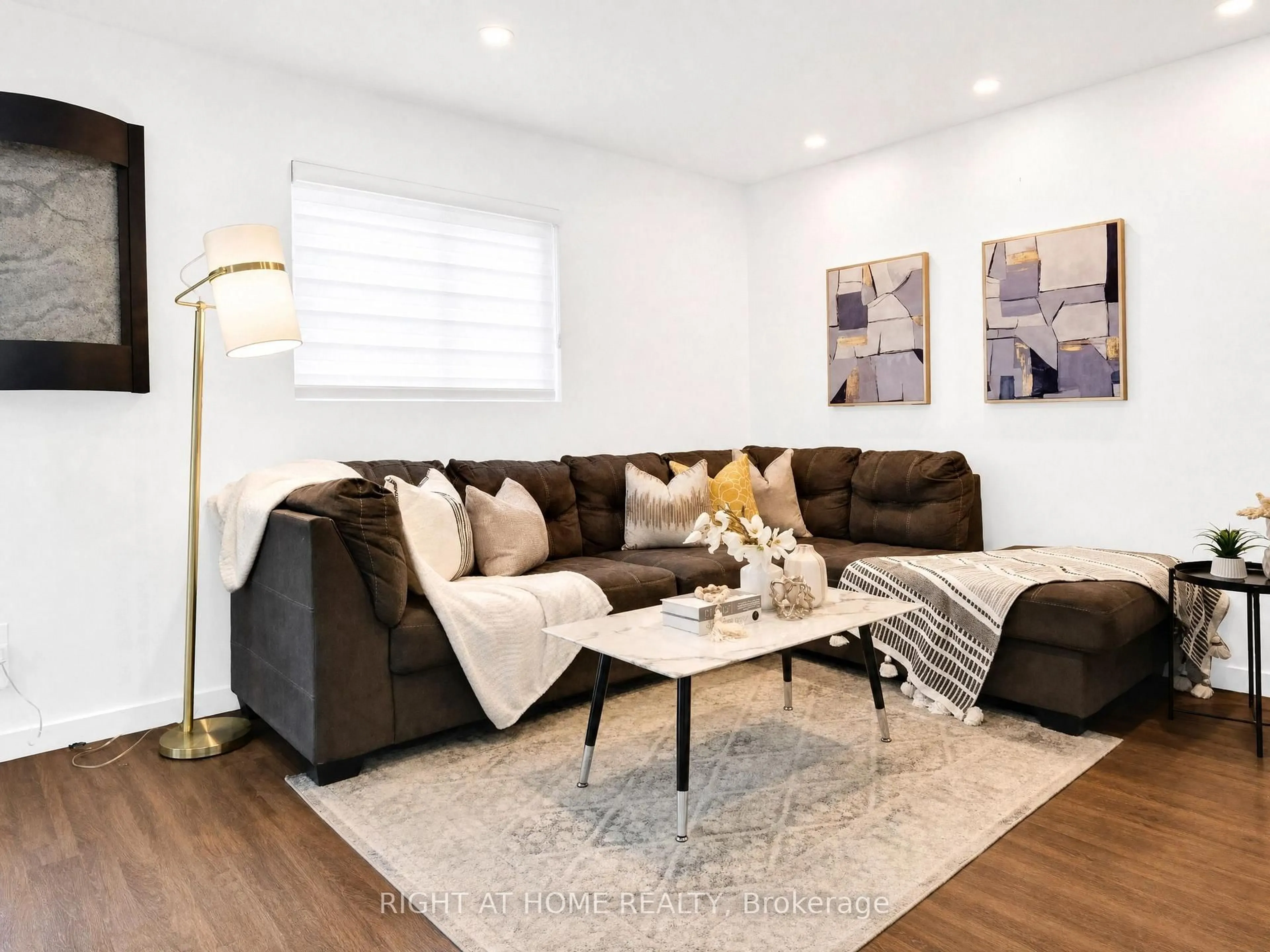 Living room with furniture, wood/laminate floor for 1055 Central Park Blvd ##4, Oshawa Ontario L1G 7M4