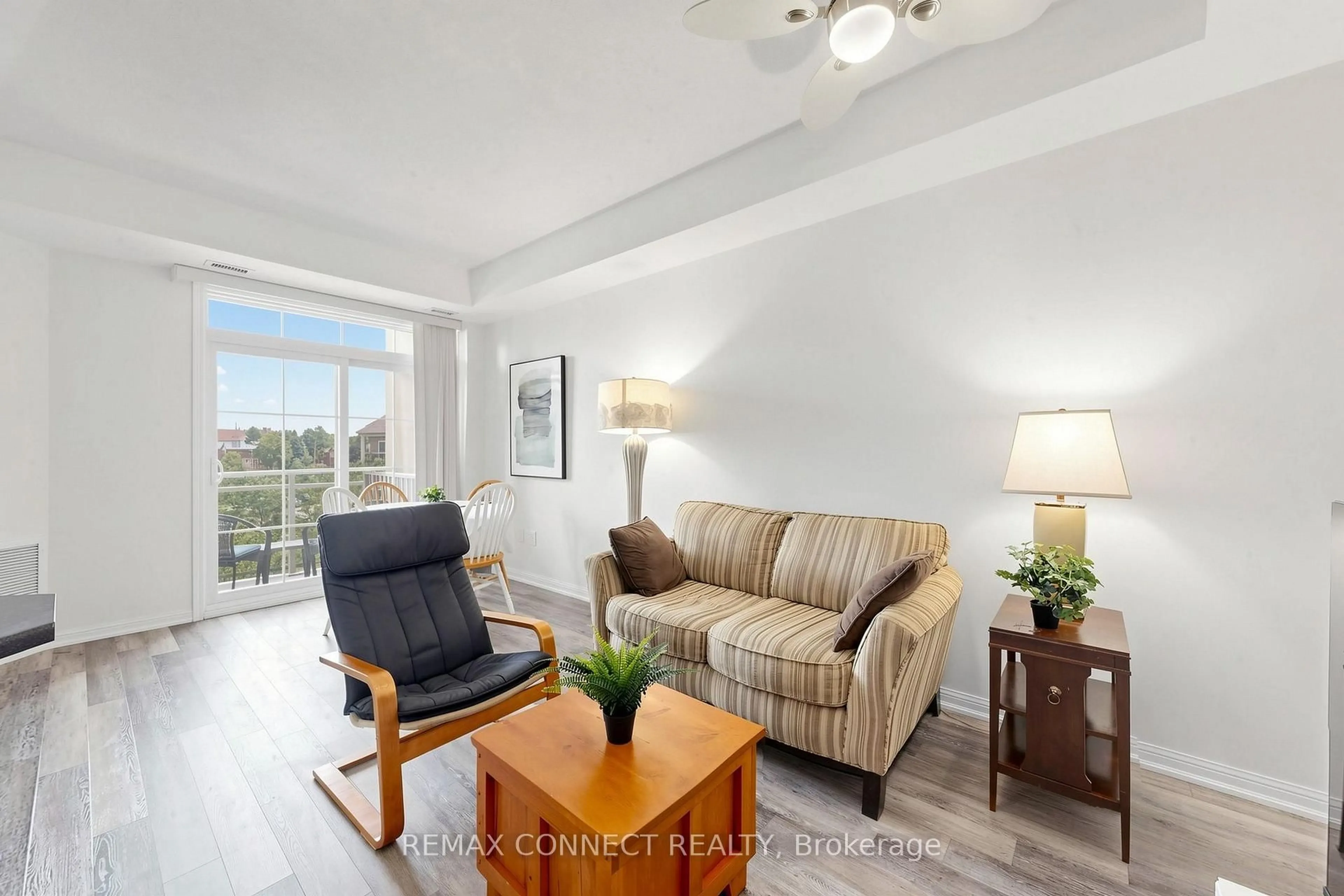Living room with furniture, wood/laminate floor for 84 Aspen Springs Dr #307, Clarington Ontario L1C 0V3