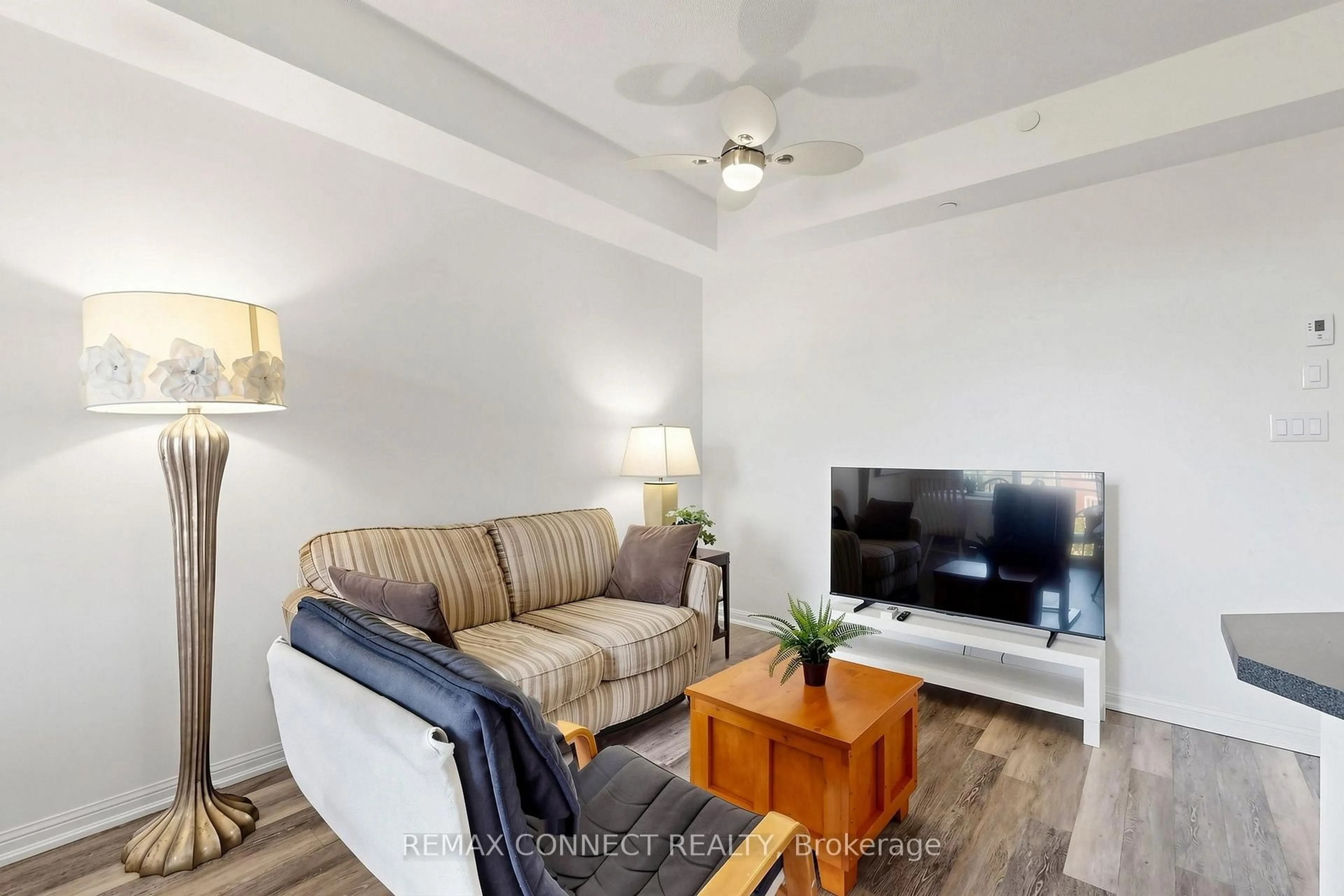 Living room with furniture, wood/laminate floor for 84 Aspen Springs Dr #307, Clarington Ontario L1C 0V3