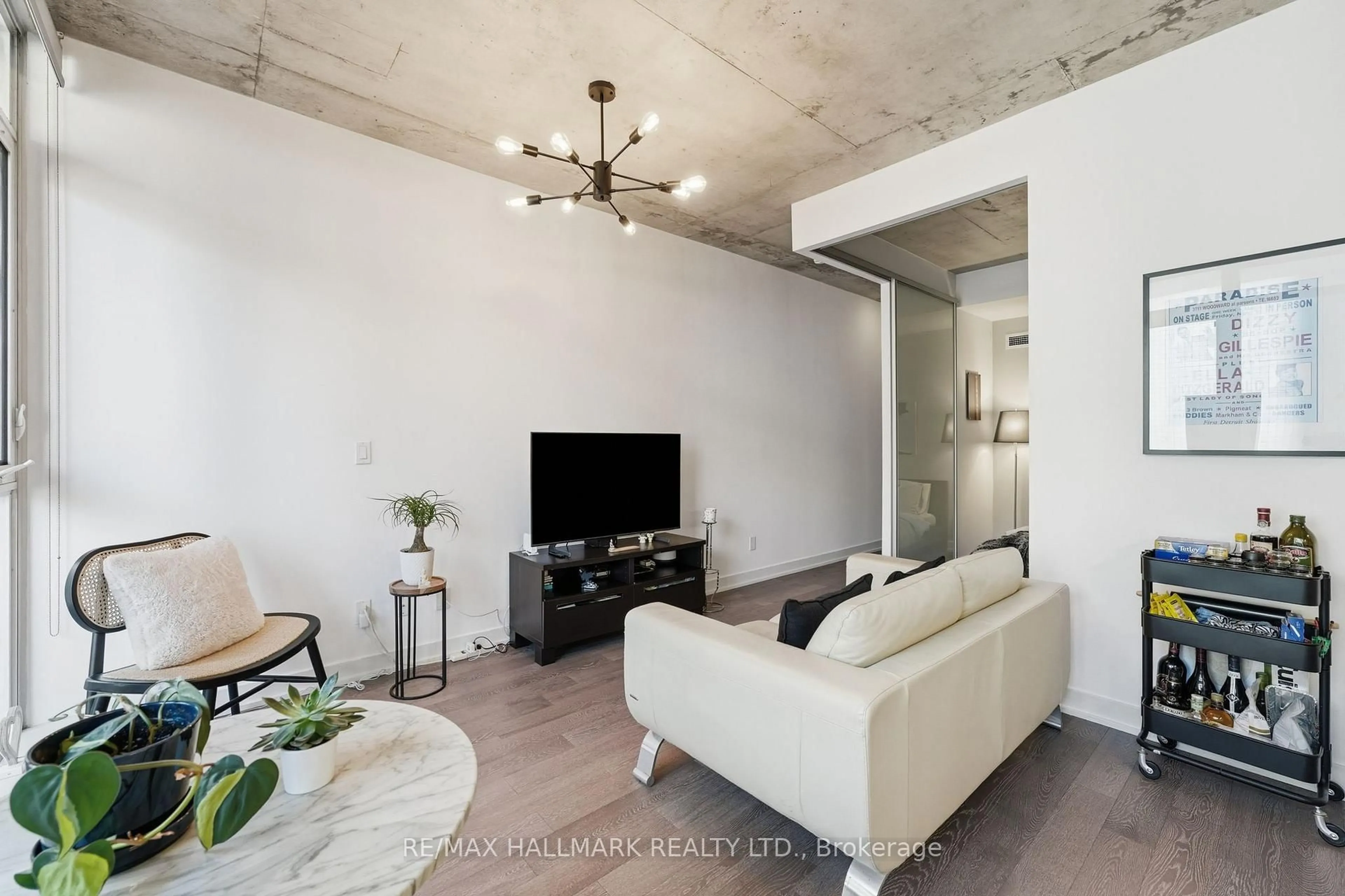 Living room with furniture, cement floor for 1190 Dundas St #323, Toronto Ontario M4M 0C5