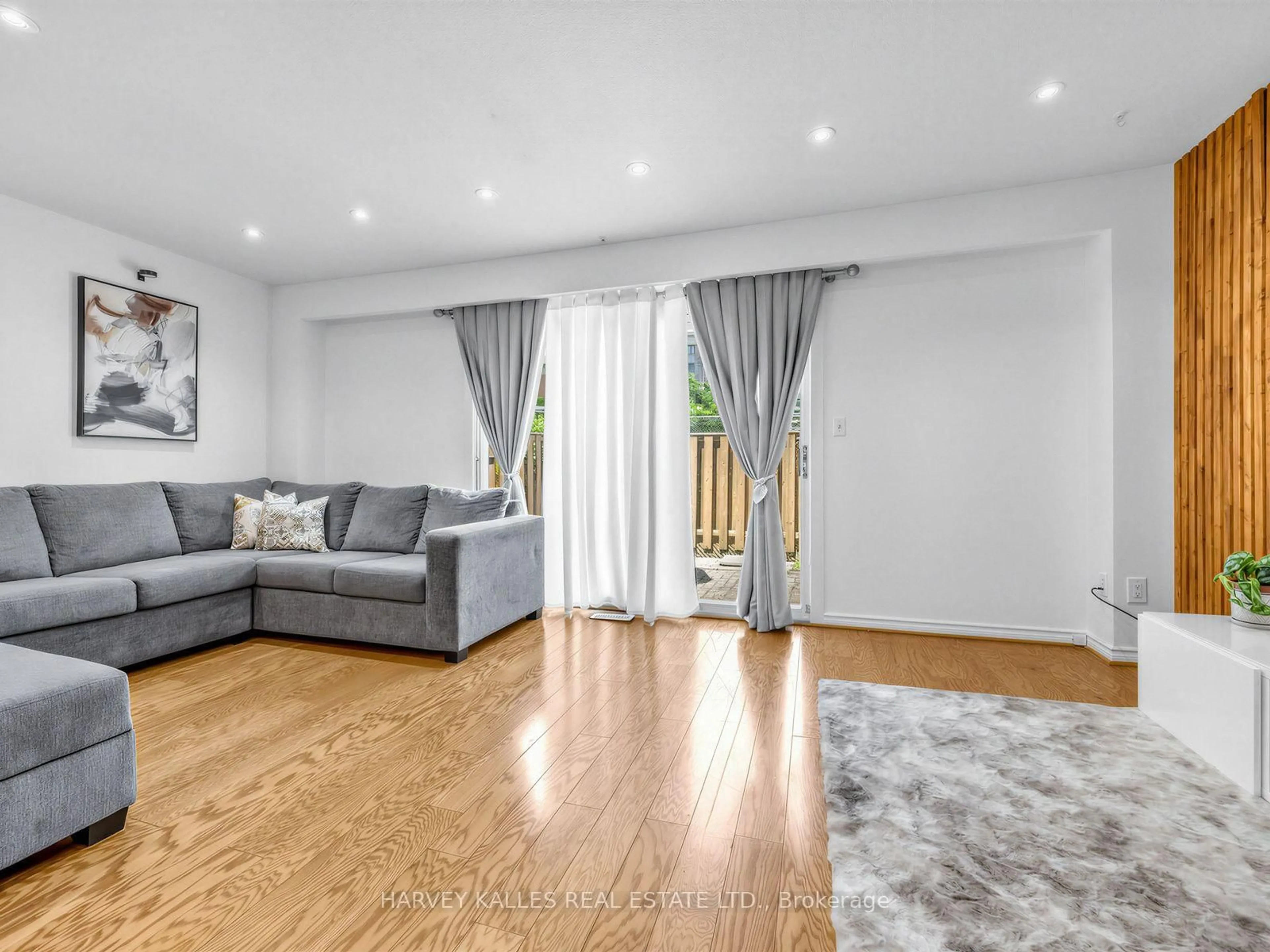 Living room with furniture, wood/laminate floor for 21 Livonia Pl #116, Toronto Ontario M1E 4W5