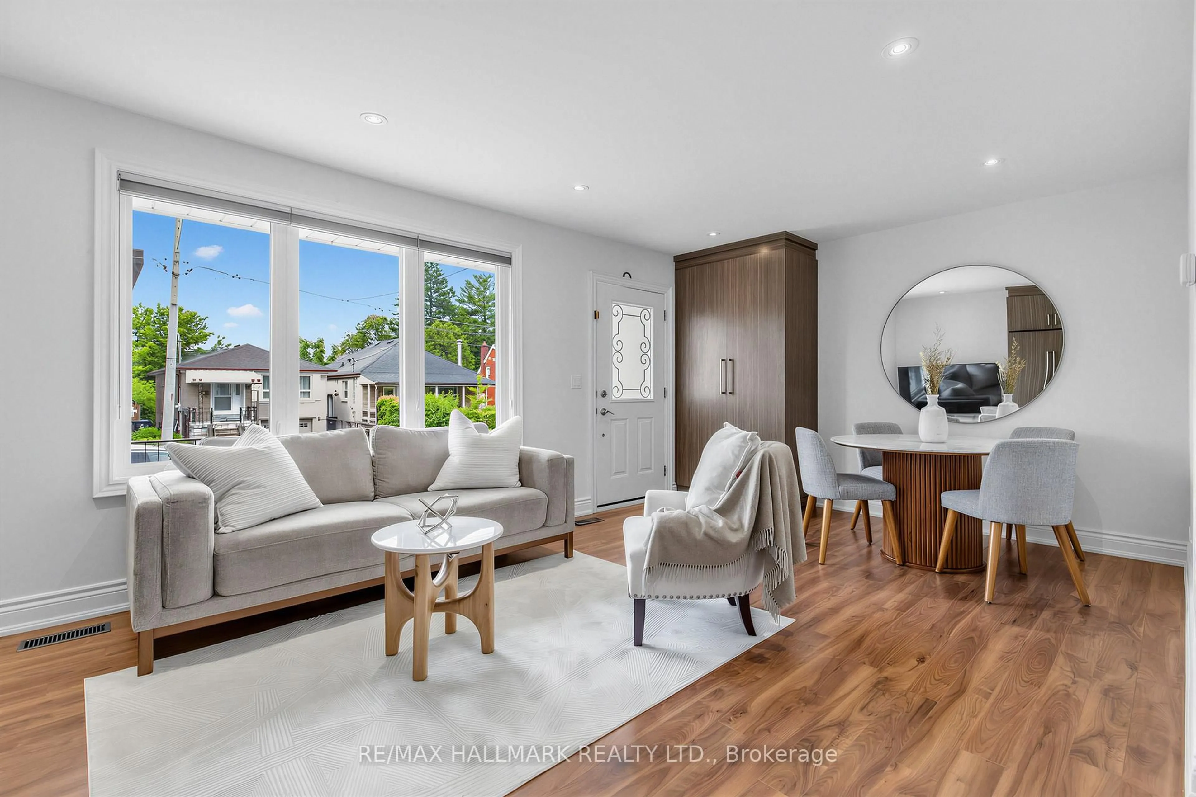 Living room with furniture, wood/laminate floor for 66 Holmstead Ave, Toronto Ontario M4B 1T2