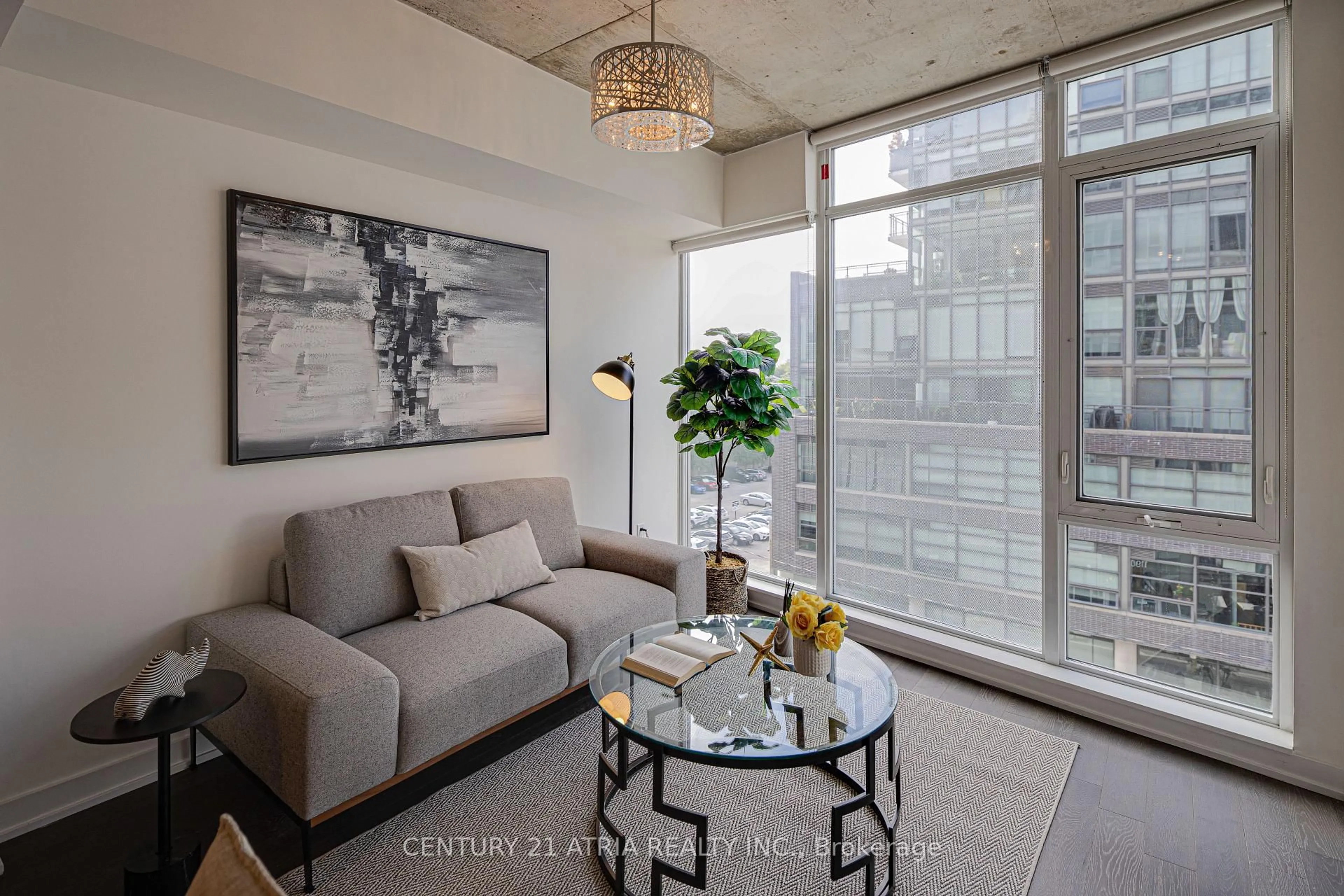 Living room with furniture, cement floor for 1190 Dundas St #513, Toronto Ontario M4M 0C5
