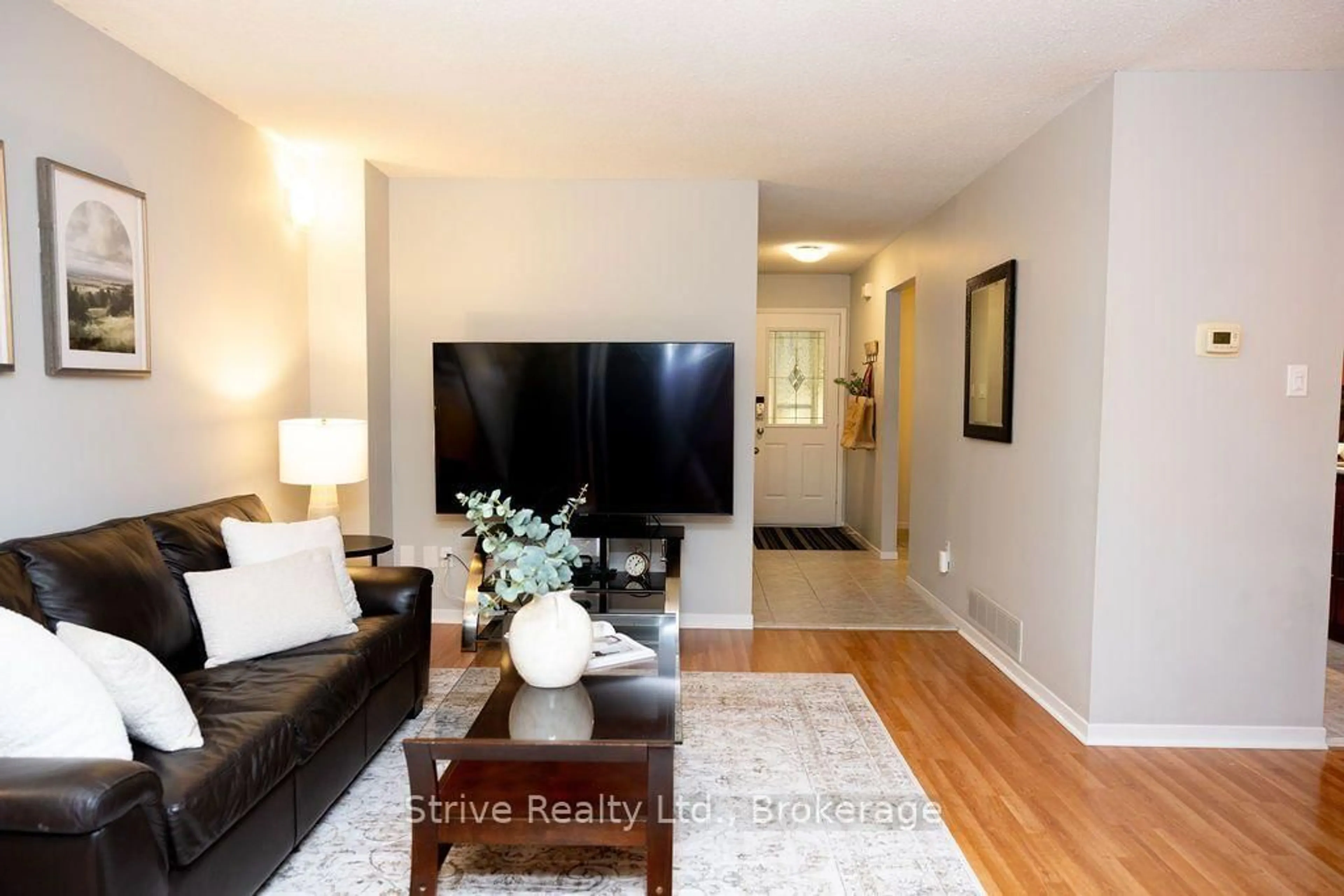 Living room with furniture, wood/laminate floor for 54 Deverill Cres, Ajax Ontario L1T 1S7