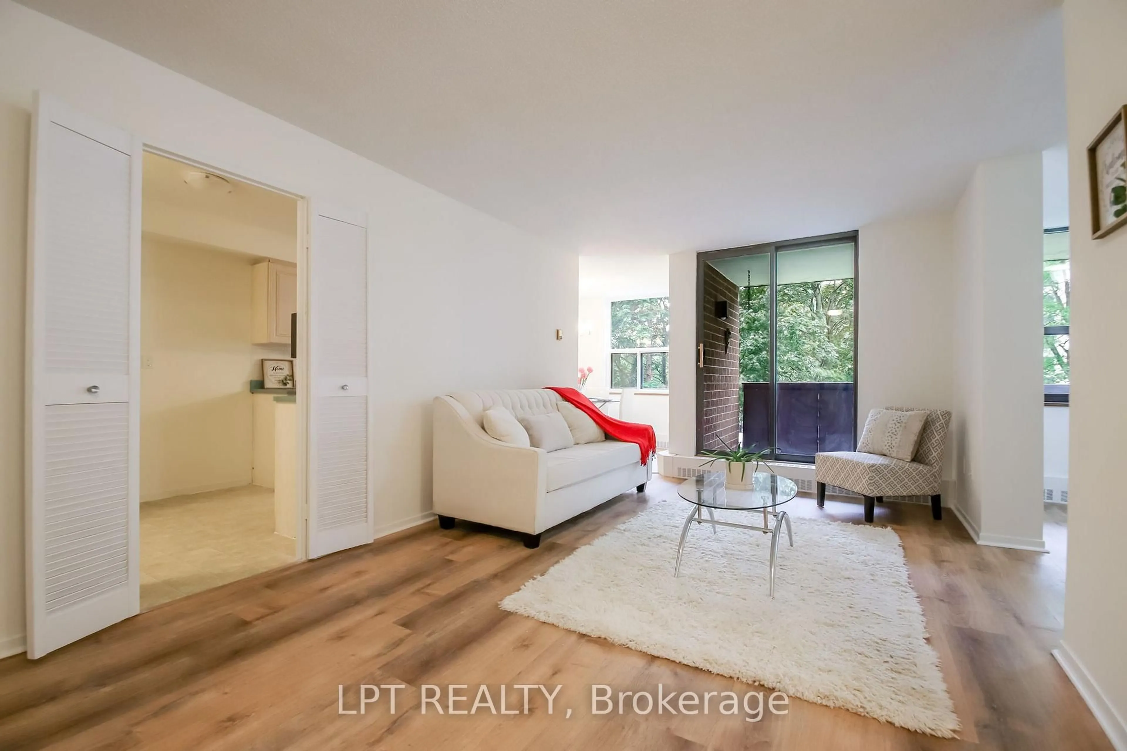 Living room with furniture, wood/laminate floor for 90 Ling Rd #209, Toronto Ontario M1E 4Y3
