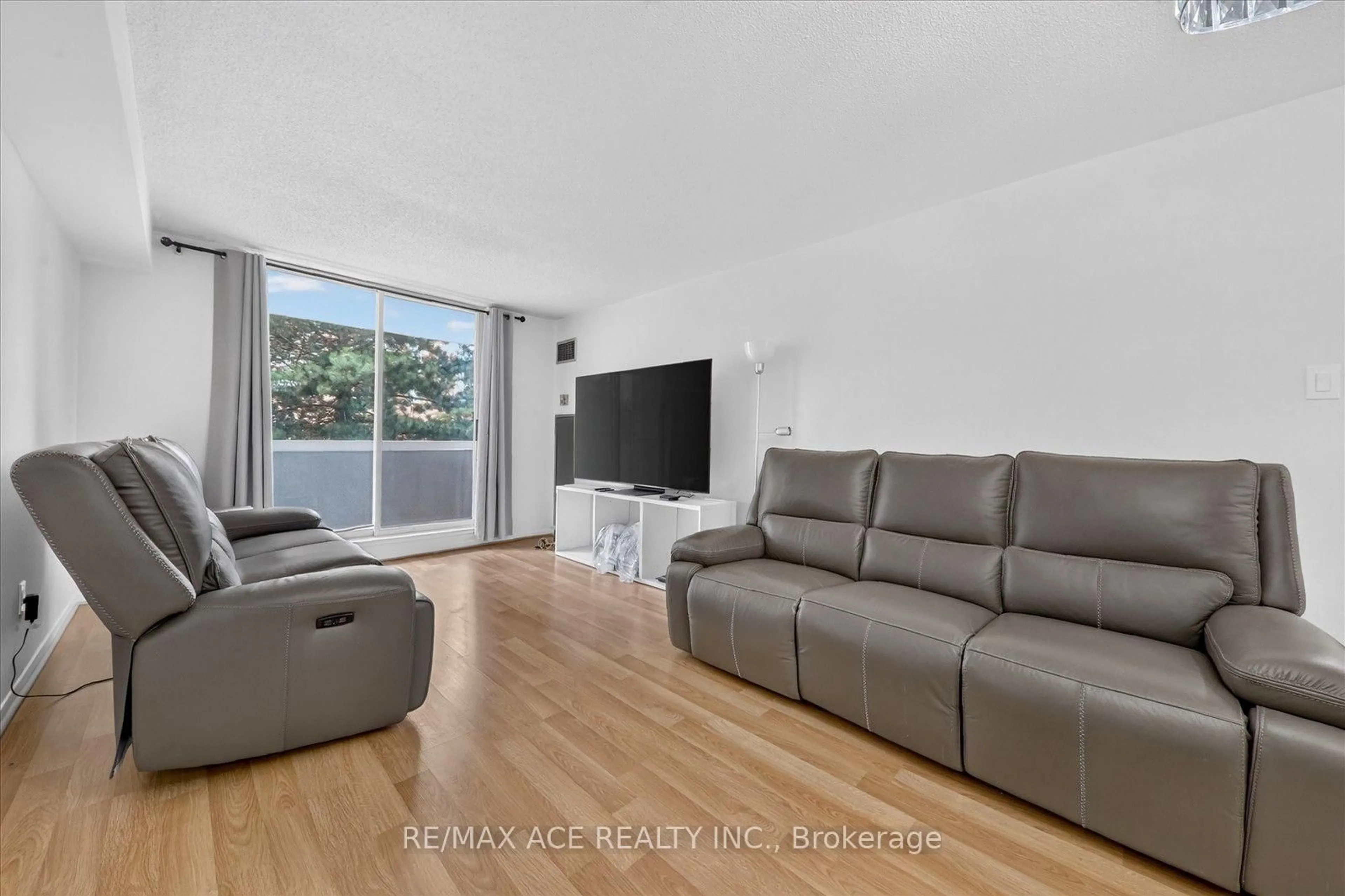 Living room with furniture, unknown for 15 Sewells Rd #201, Toronto Ontario M1B 3V7