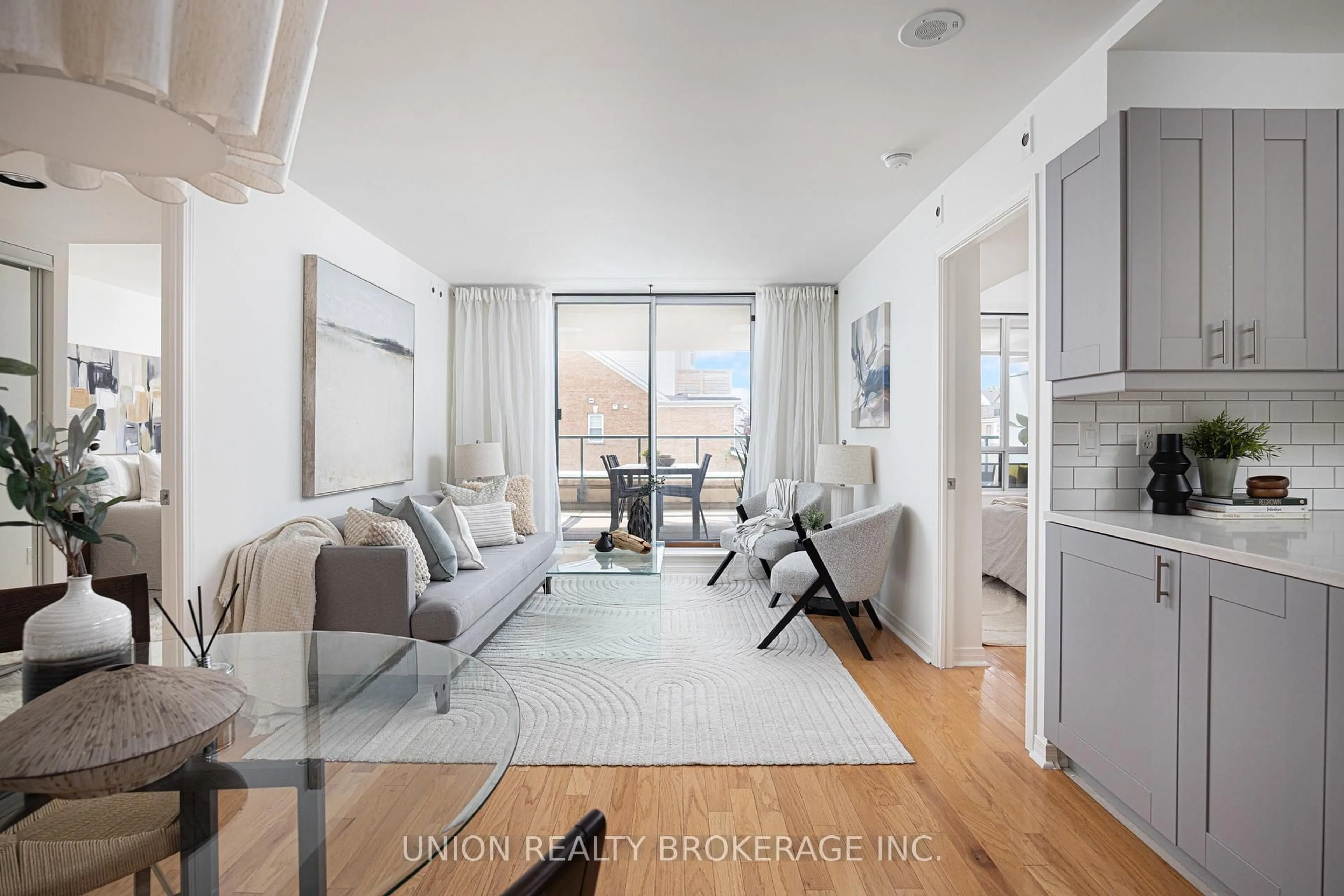 Living room with furniture, wood/laminate floor for 1765 Queen St #213, Toronto Ontario M4L 3Z2