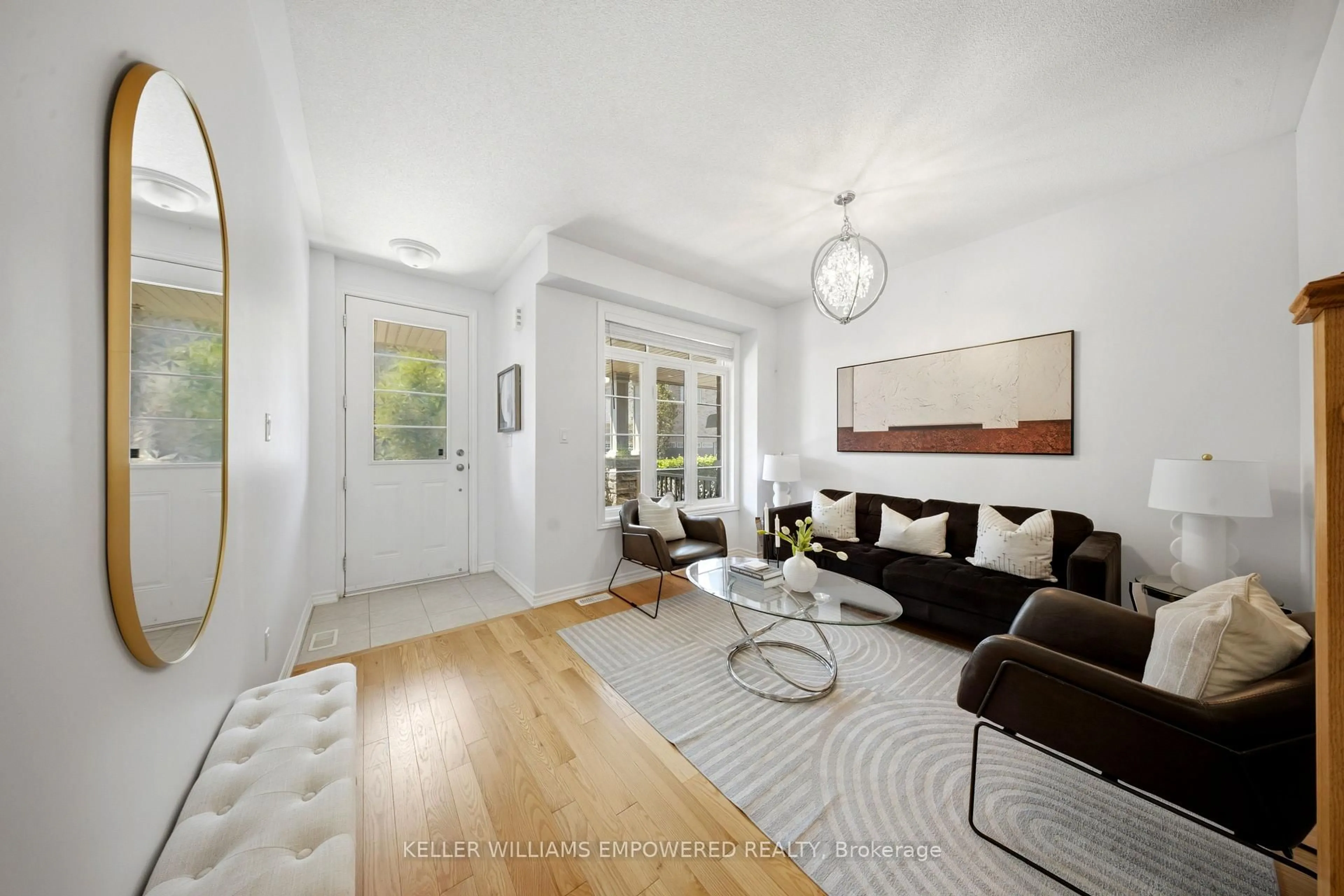 Living room with furniture, wood/laminate floor for 68 Workmens Circ, Ajax Ontario L1T 0N7