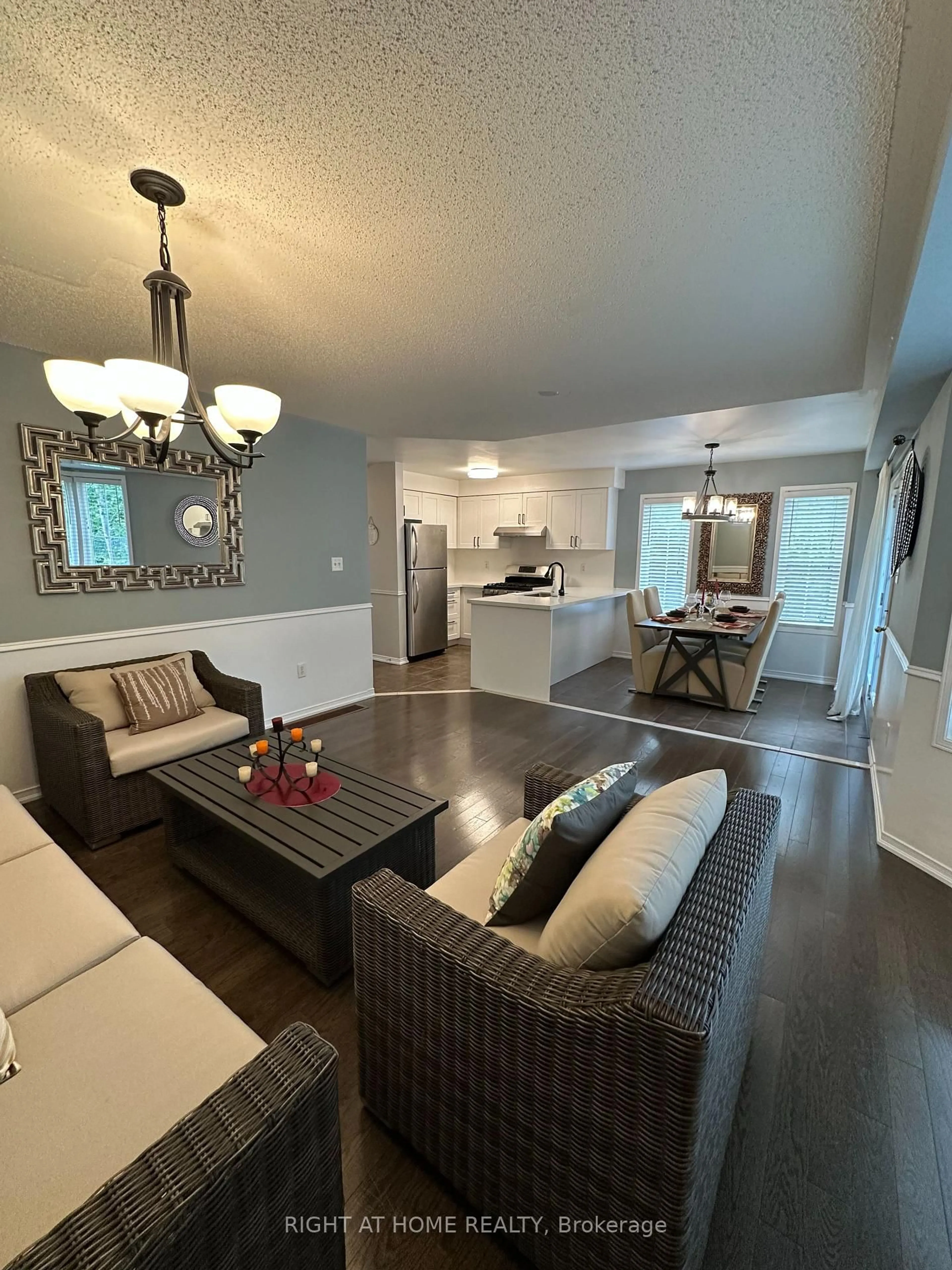 Living room with furniture, wood/laminate floor for 107 Norland Circ, Oshawa Ontario L1L 0A7