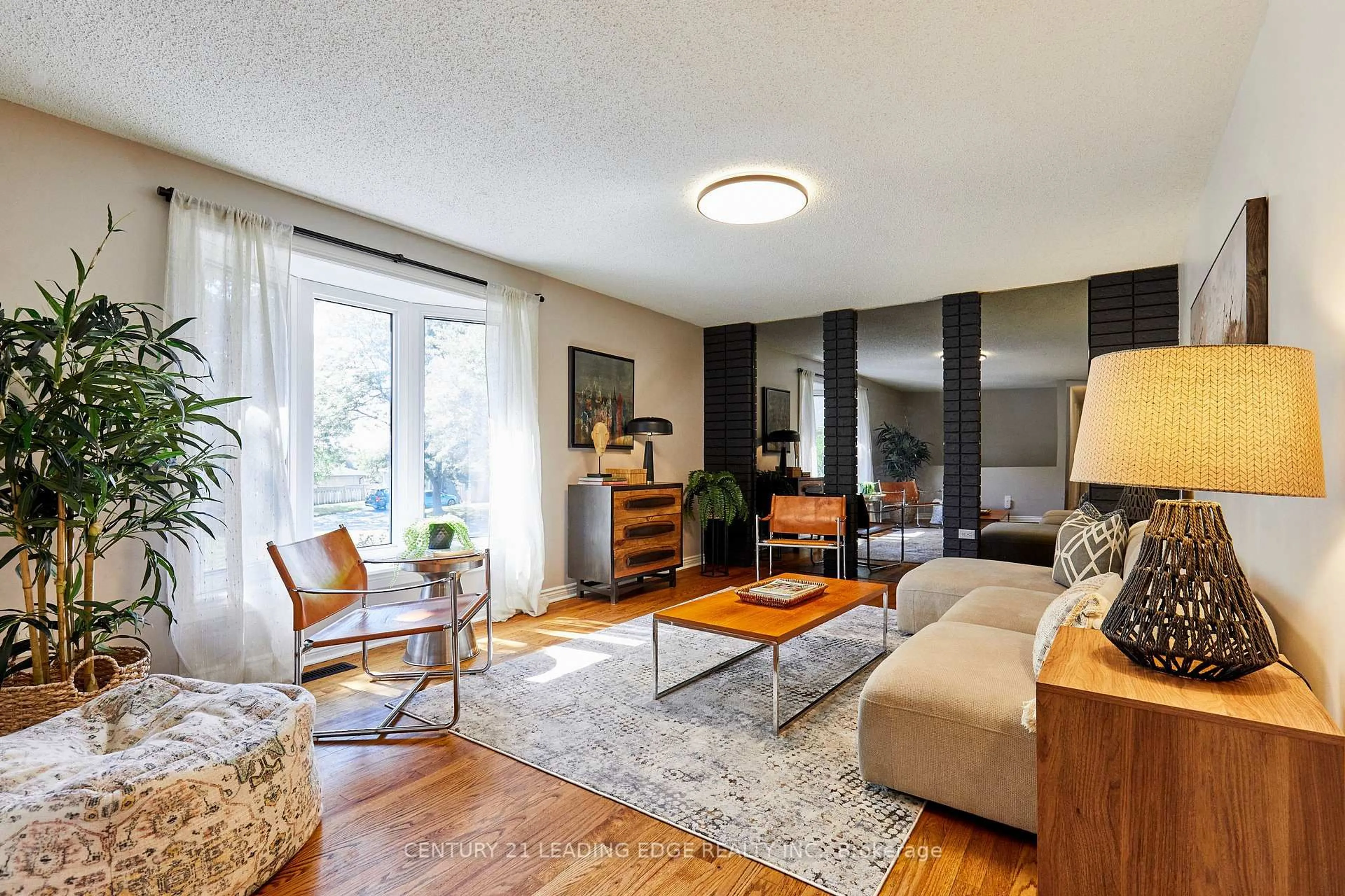 Living room with furniture, wood/laminate floor for 1229 Norman Crt, Oshawa Ontario L1H 7X2