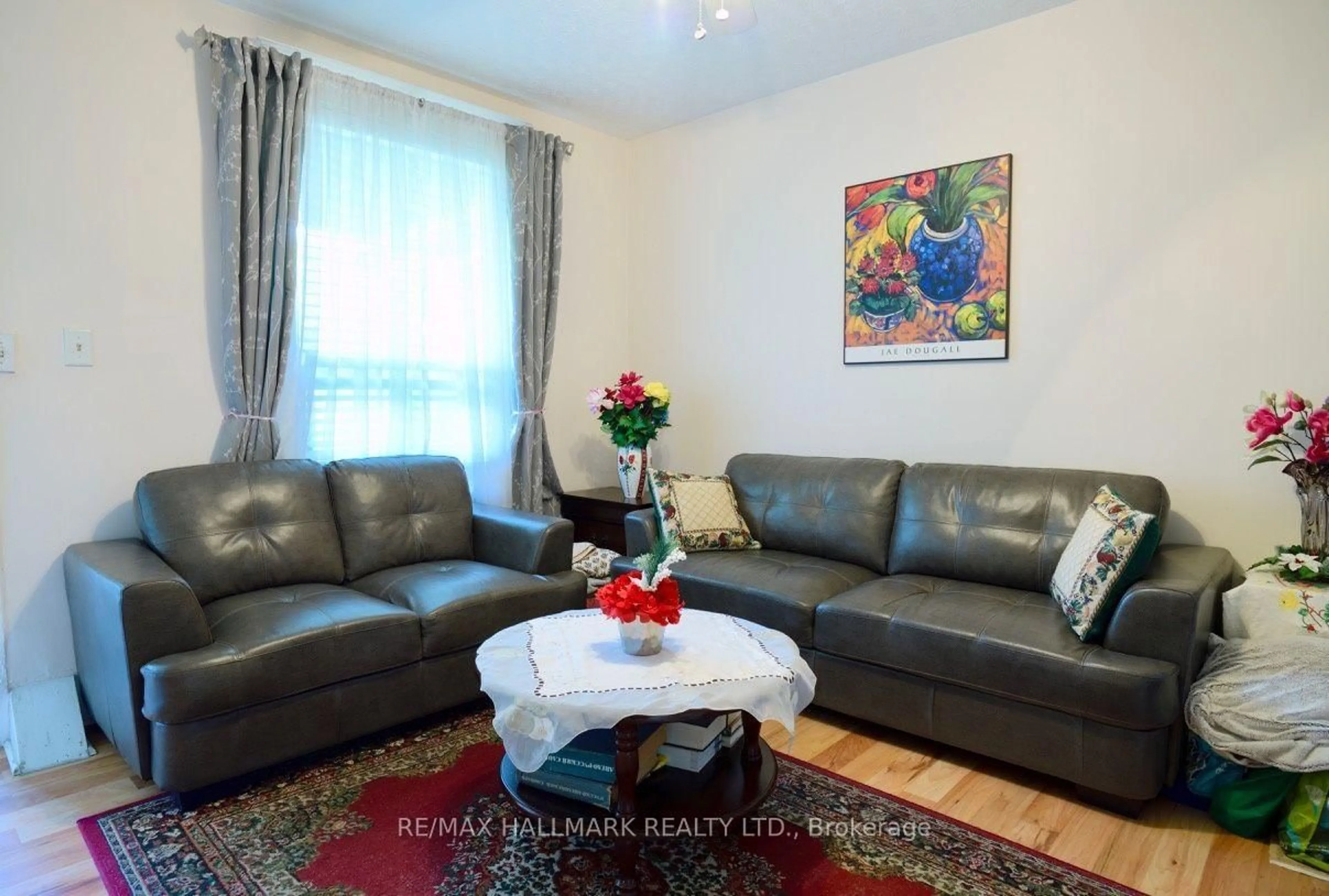 Living room with furniture, wood/laminate floor for 47 Dentonia Park Ave, Toronto Ontario M4C 1W6