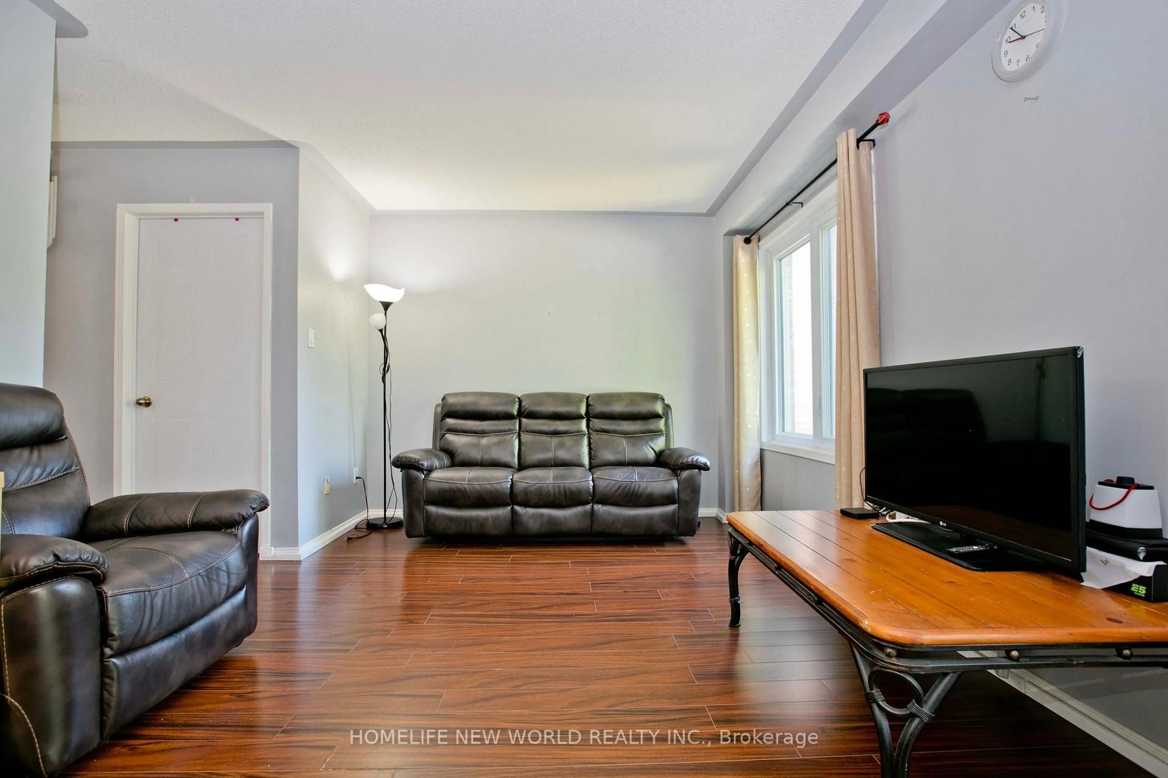 Living room with furniture, wood/laminate floor for 1814 Woodgate Crt, Oshawa Ontario L1G 7Z1