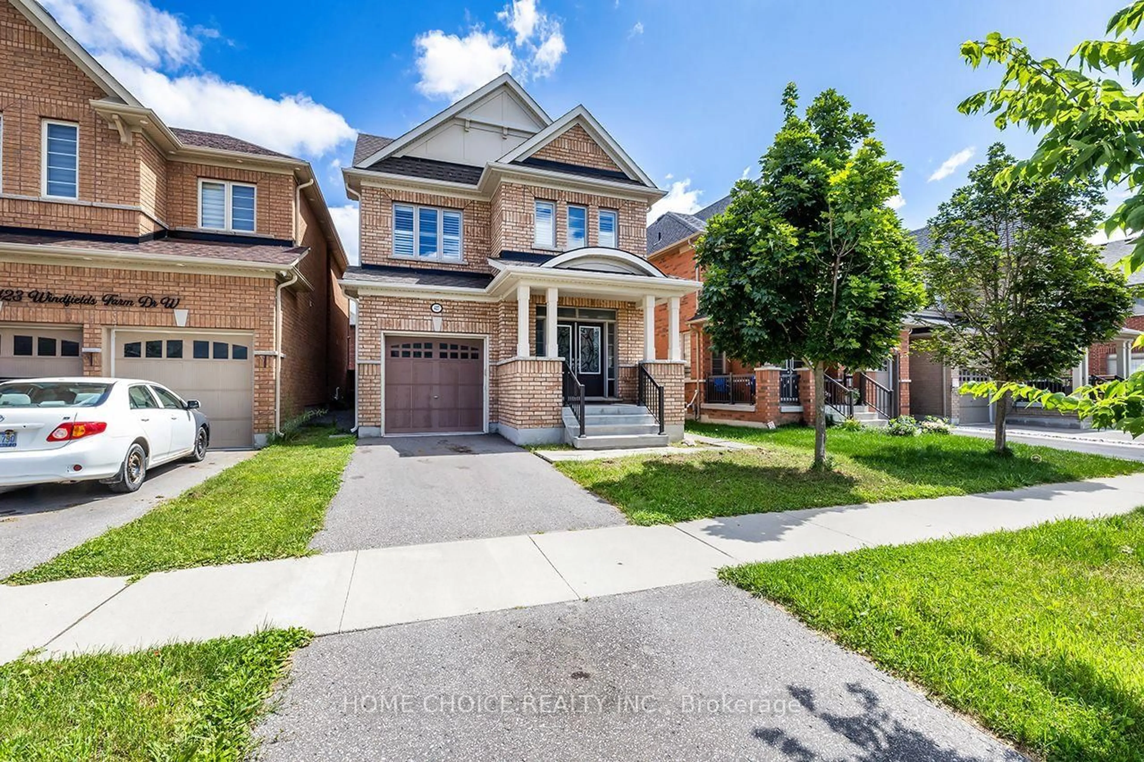 Home with brick exterior material, street for 427 WINDSFIELDS FARM Dr, Oshawa Ontario L1L 0M1