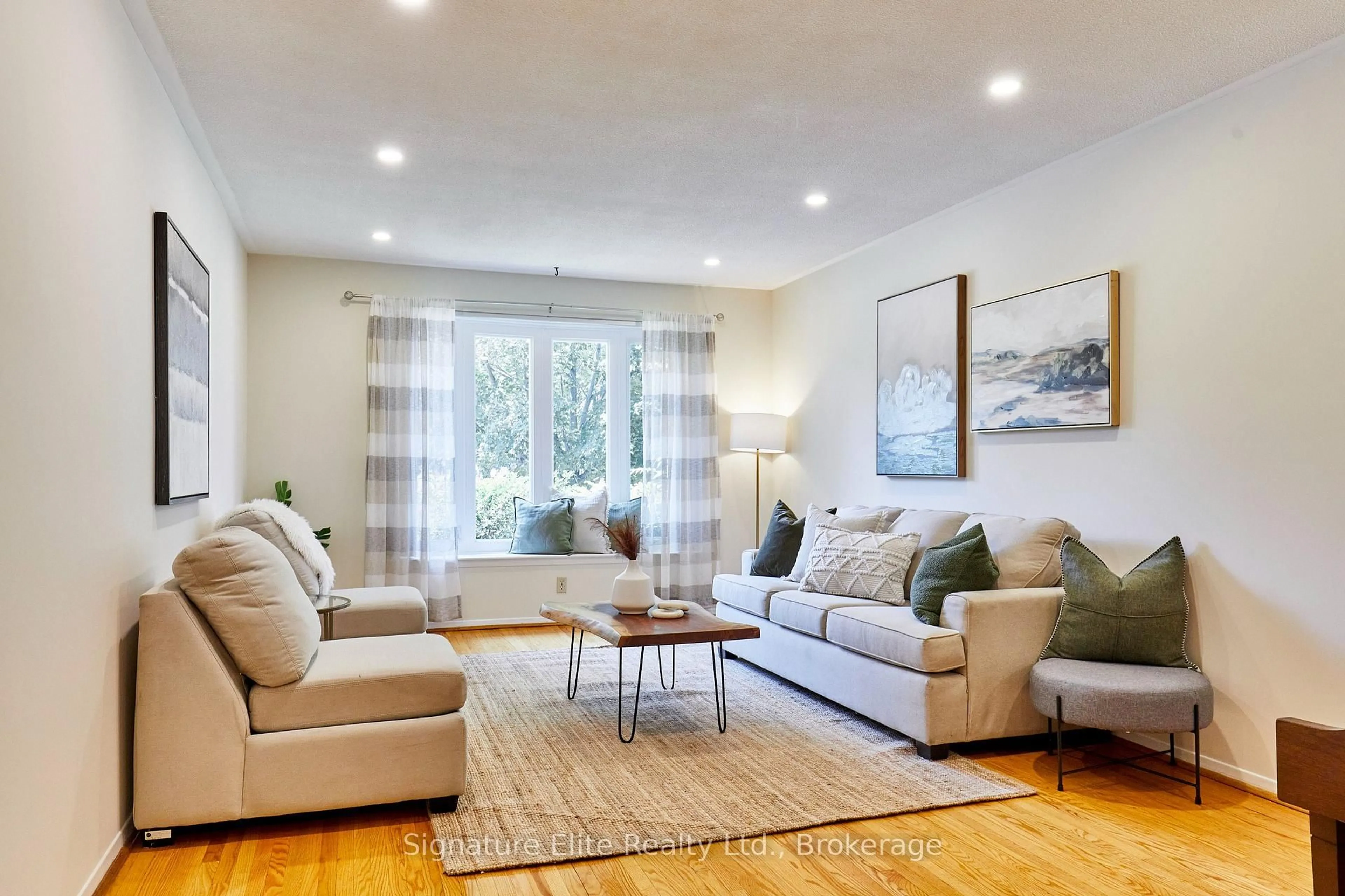 Living room with furniture, wood/laminate floor for 65 Merkley Sq, Toronto Ontario M1G 2Y5