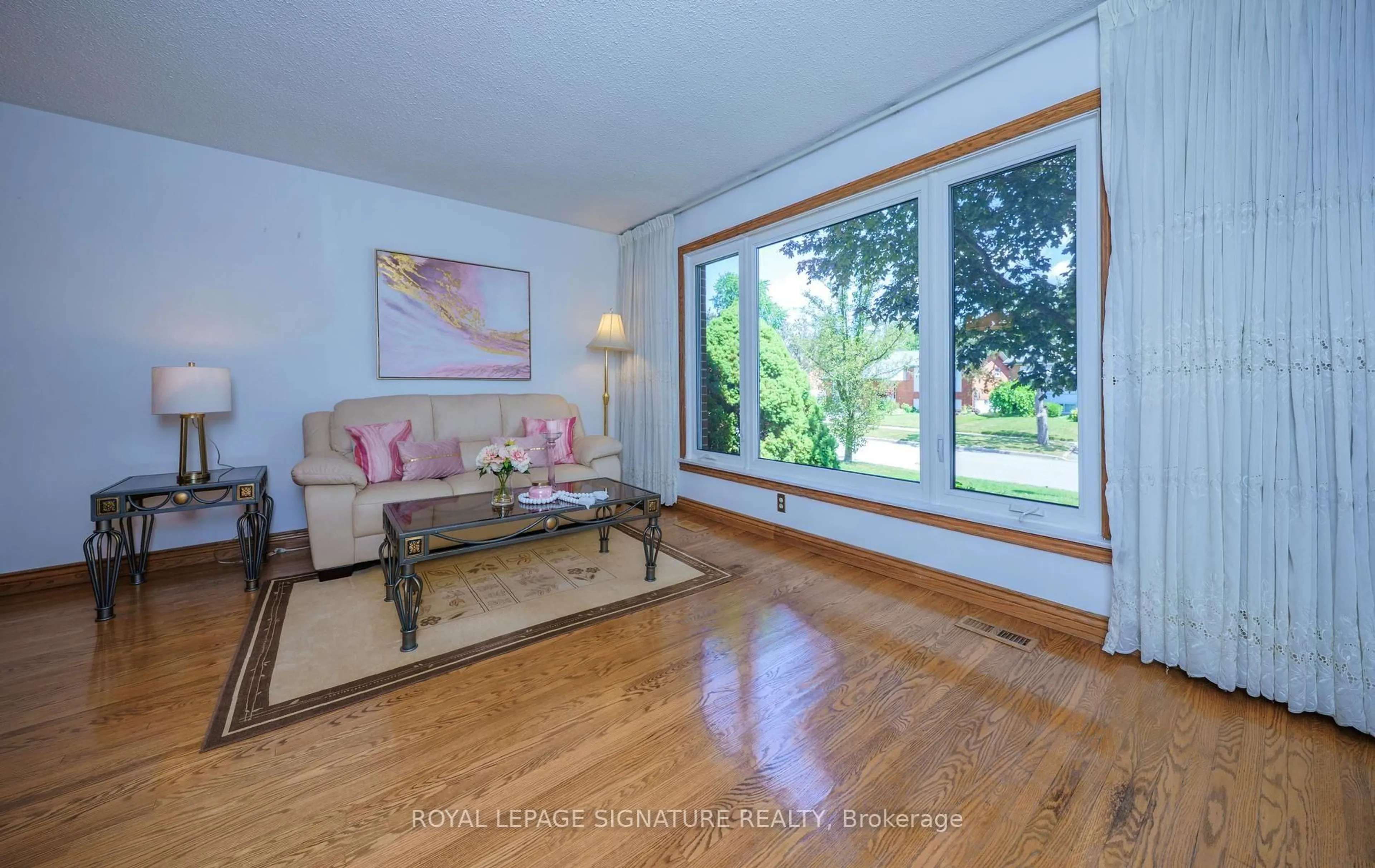 Living room with furniture, wood/laminate floor for 34 Rainier Sq, Toronto Ontario M1T 2Z9