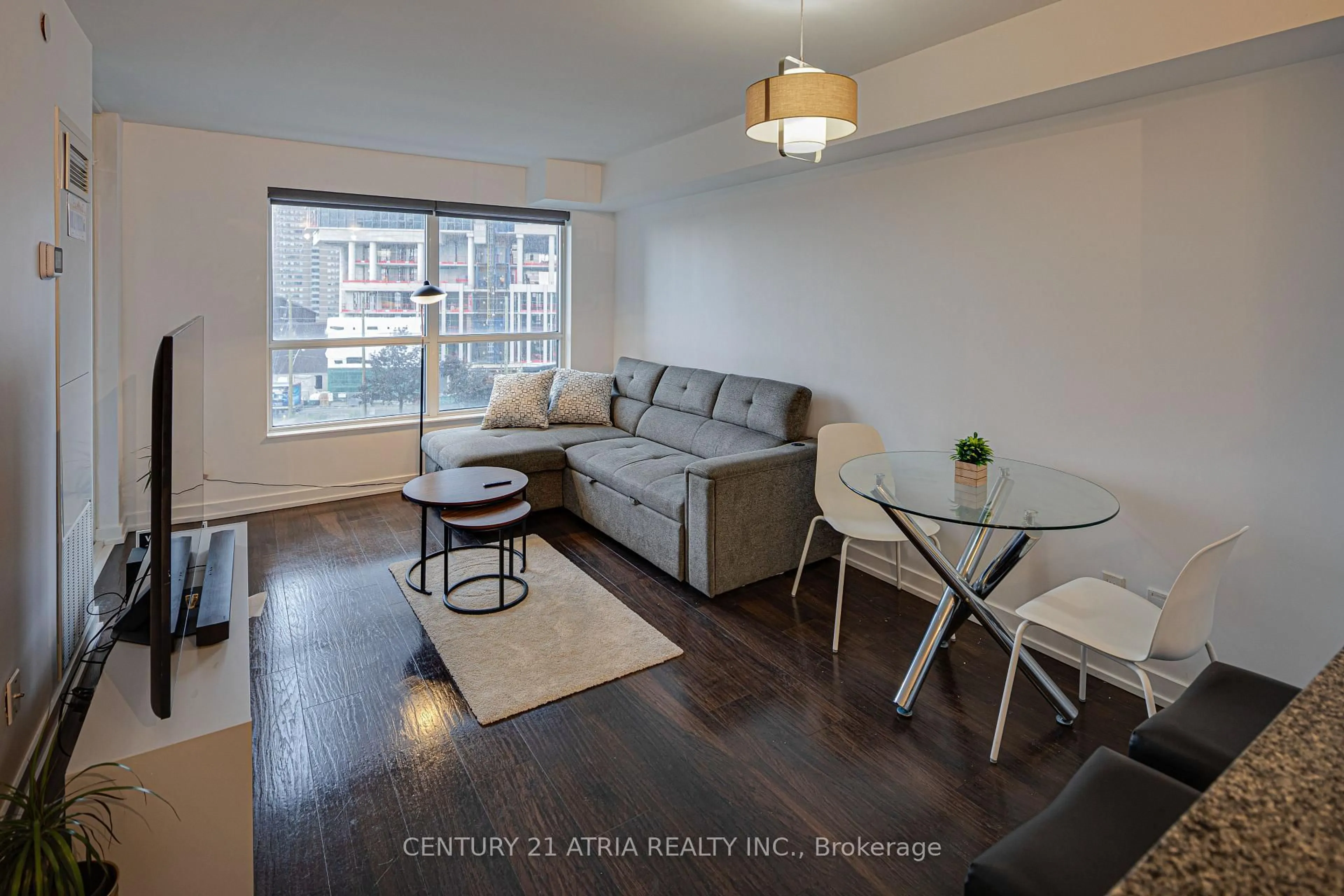 Living room with furniture, wood/laminate floor for 8 Trent Ave #503, Toronto Ontario M4C 0A6