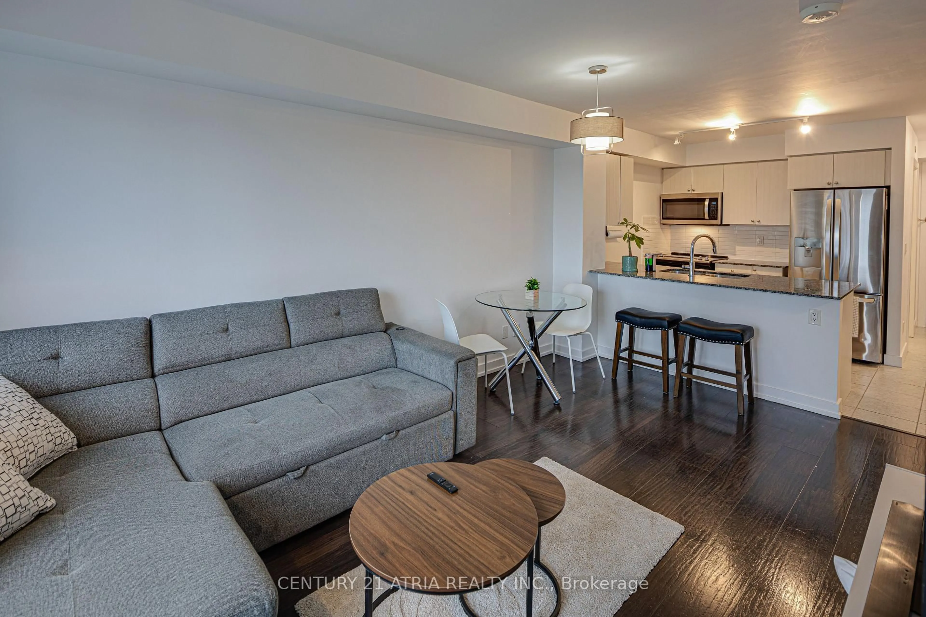 Living room with furniture, wood/laminate floor for 8 Trent Ave #503, Toronto Ontario M4C 0A6