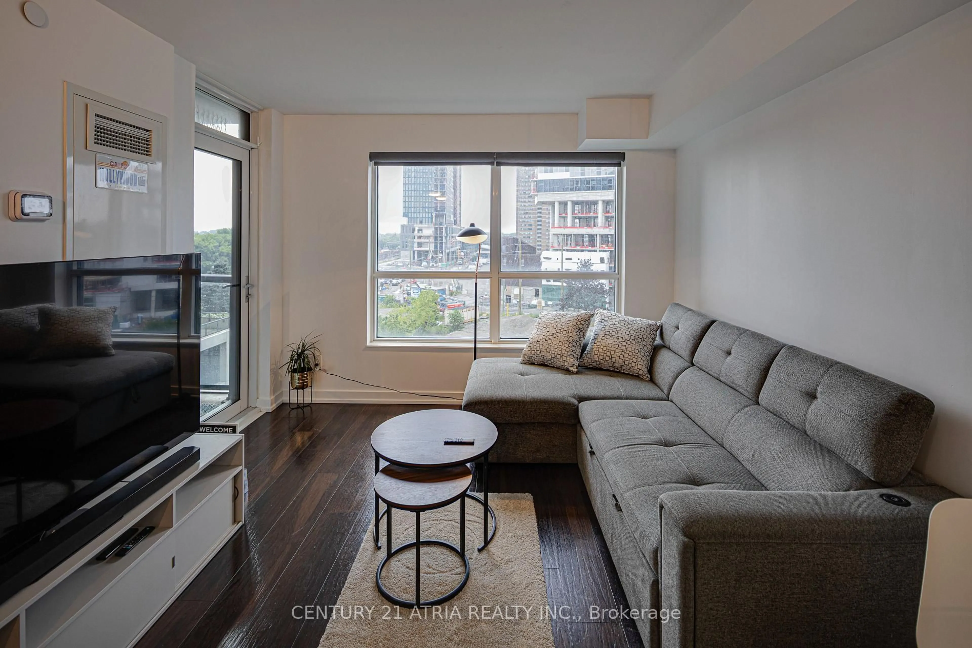 Living room with furniture, wood/laminate floor for 8 Trent Ave #503, Toronto Ontario M4C 0A6