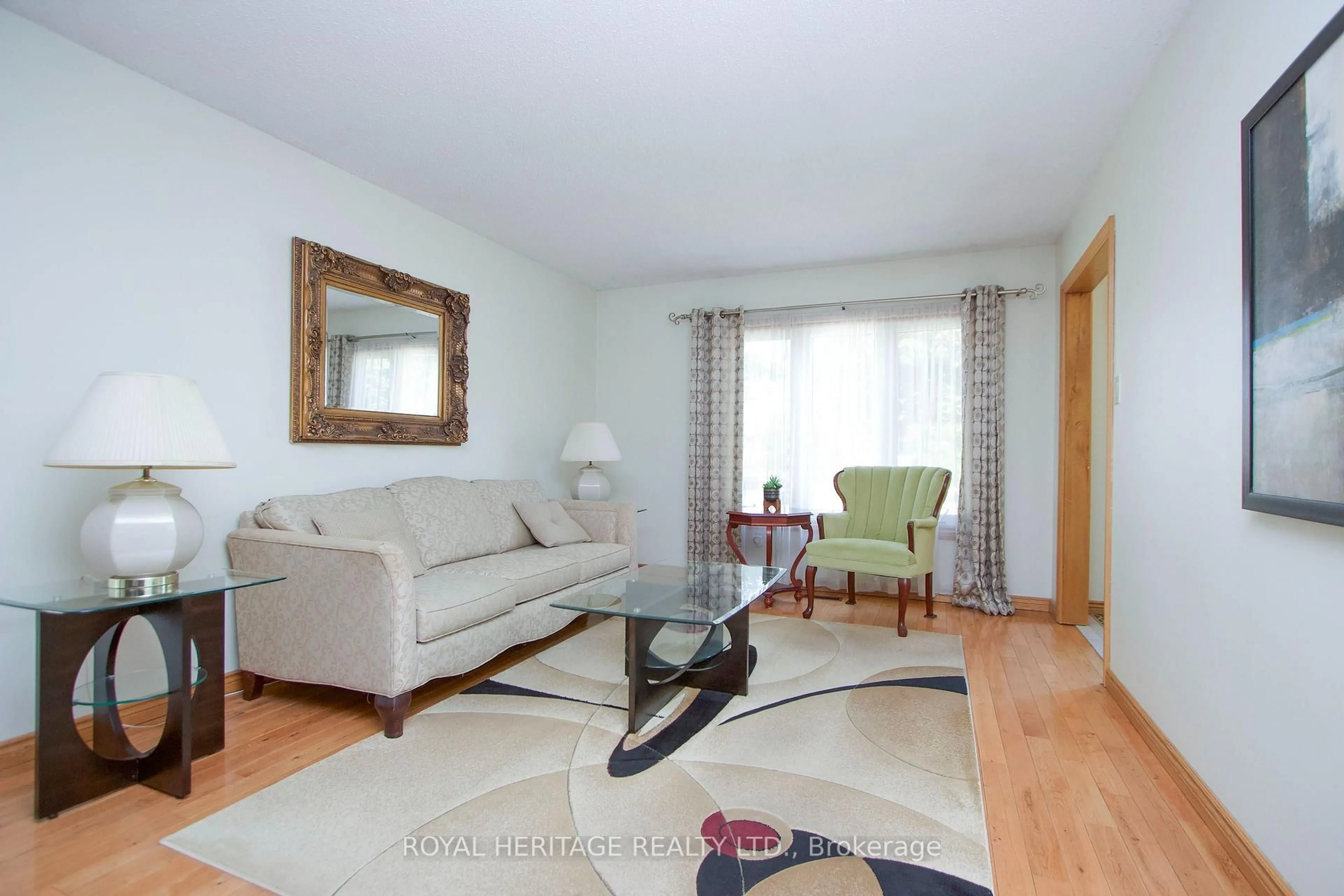 Living room with furniture, wood/laminate floor for 718 Annes St, Whitby Ontario L1N 6B2