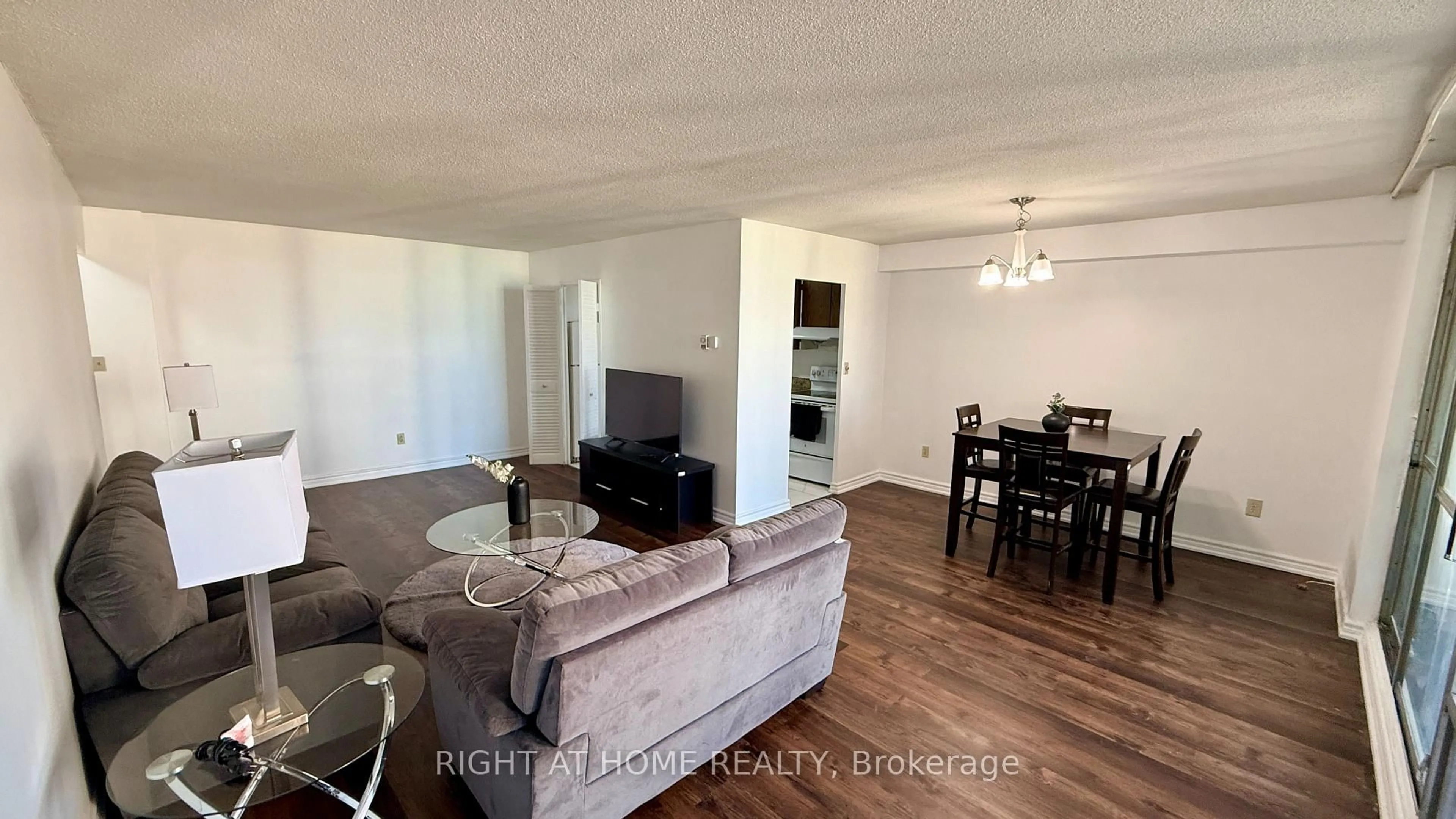 Living room with furniture, wood/laminate floor for 1 Massey Sq #2819, Toronto Ontario M4C 5L4