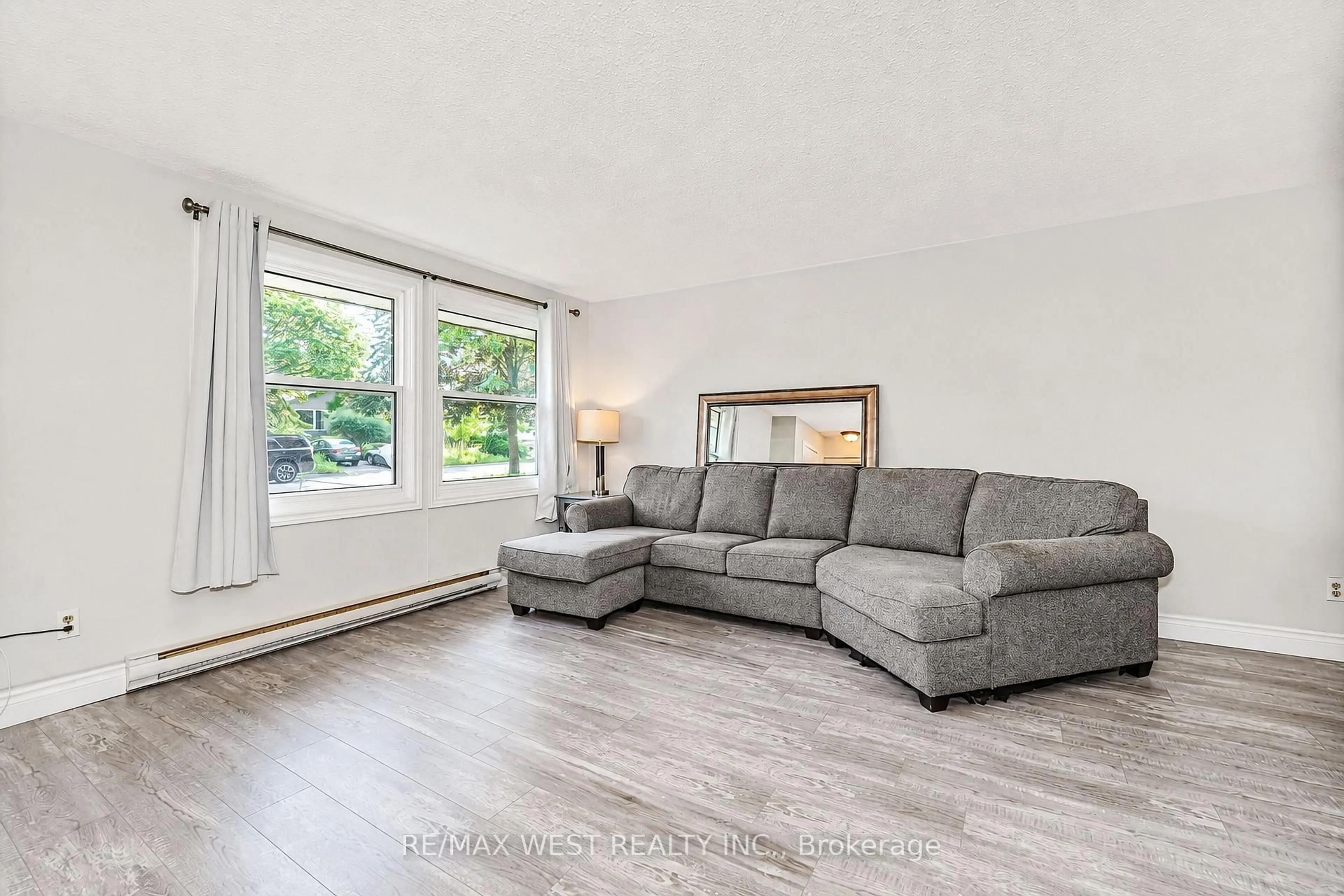 Living room with furniture, wood/laminate floor for 570 Annandale St, Oshawa Ontario L1H 7S7