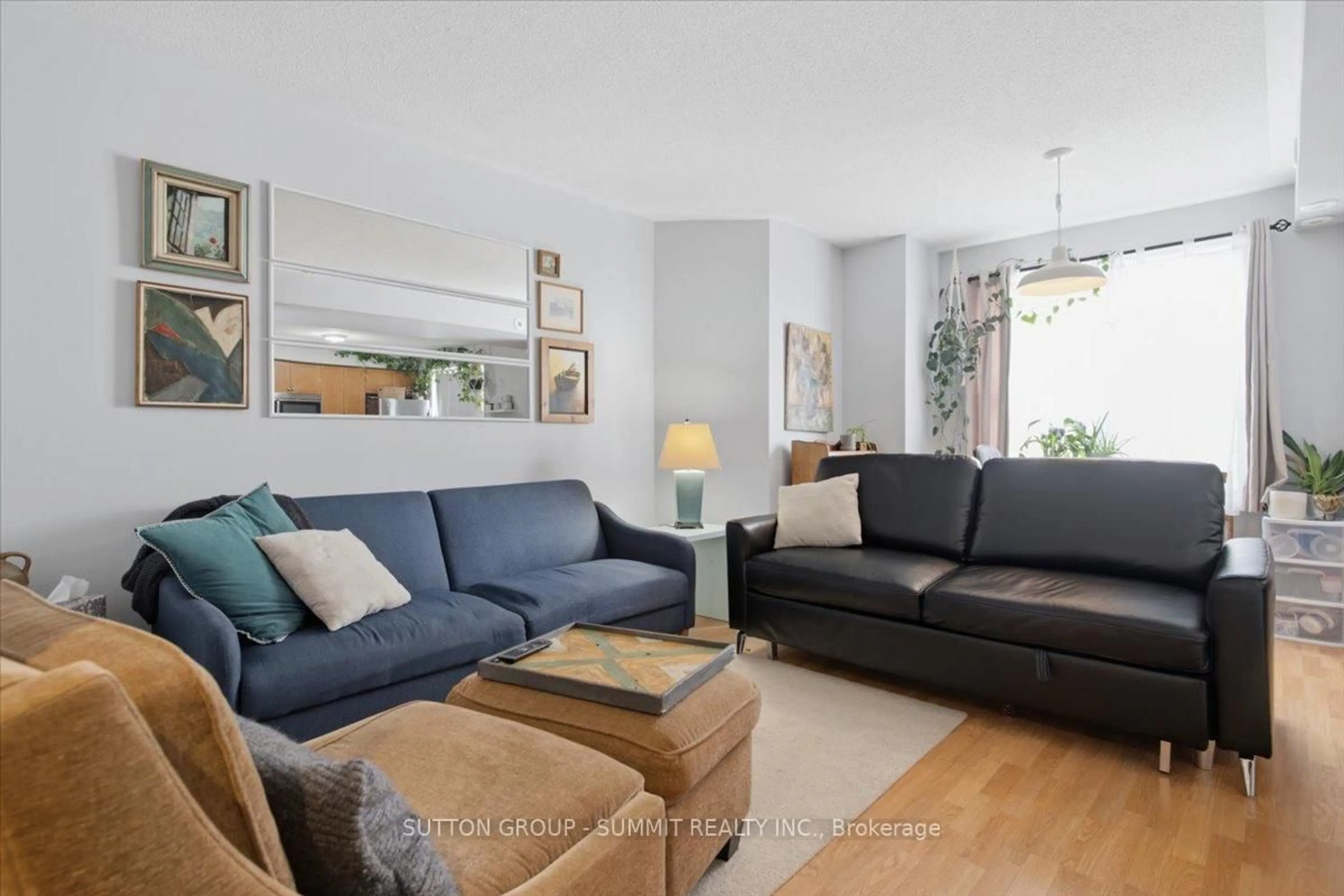 Living room with furniture, wood/laminate floor for 25 Strangford Lane #201, Toronto Ontario M1L 0E5