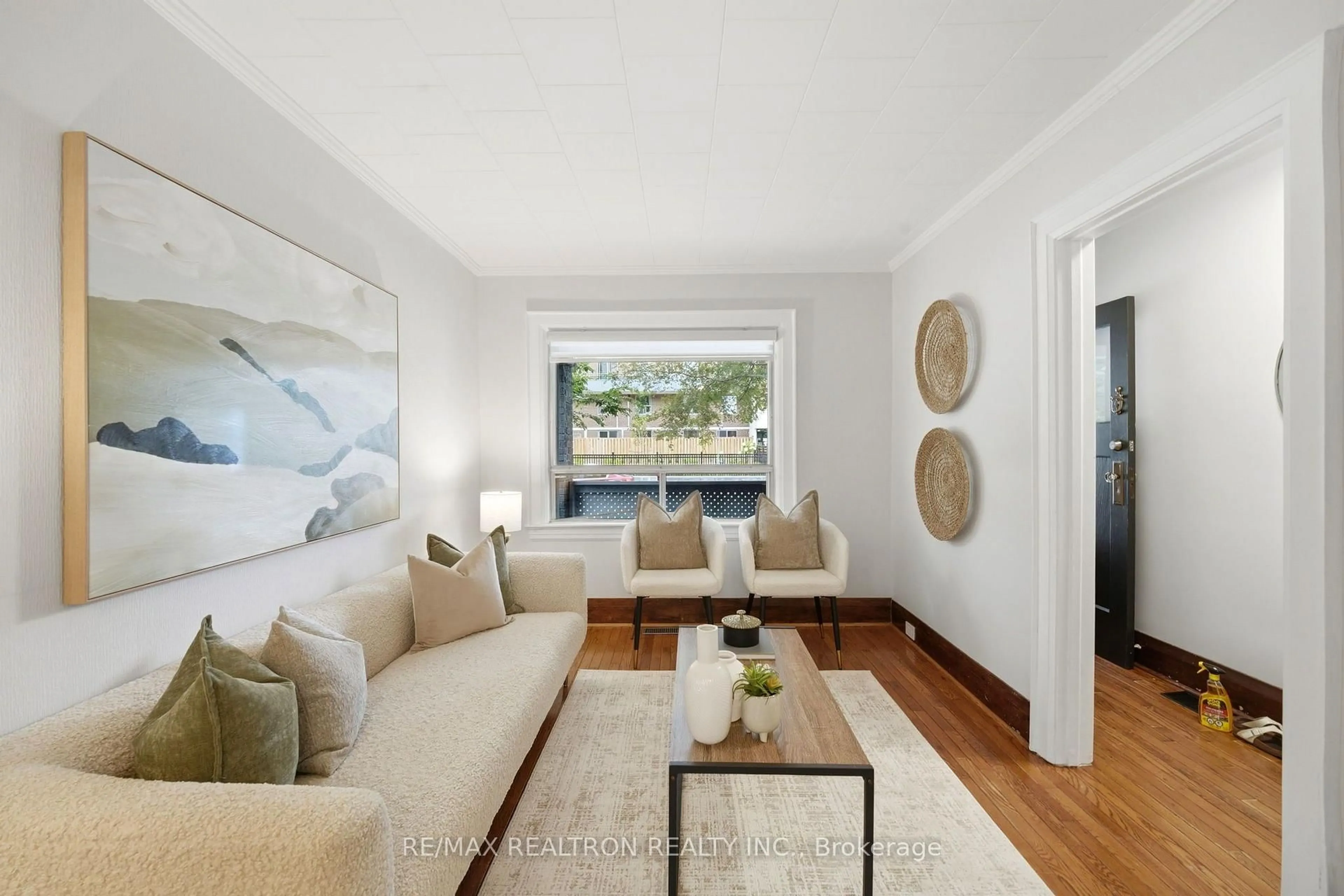 Living room with furniture, wood/laminate floor for 1056 Woodbine Ave, Toronto Ontario M4C 4C5