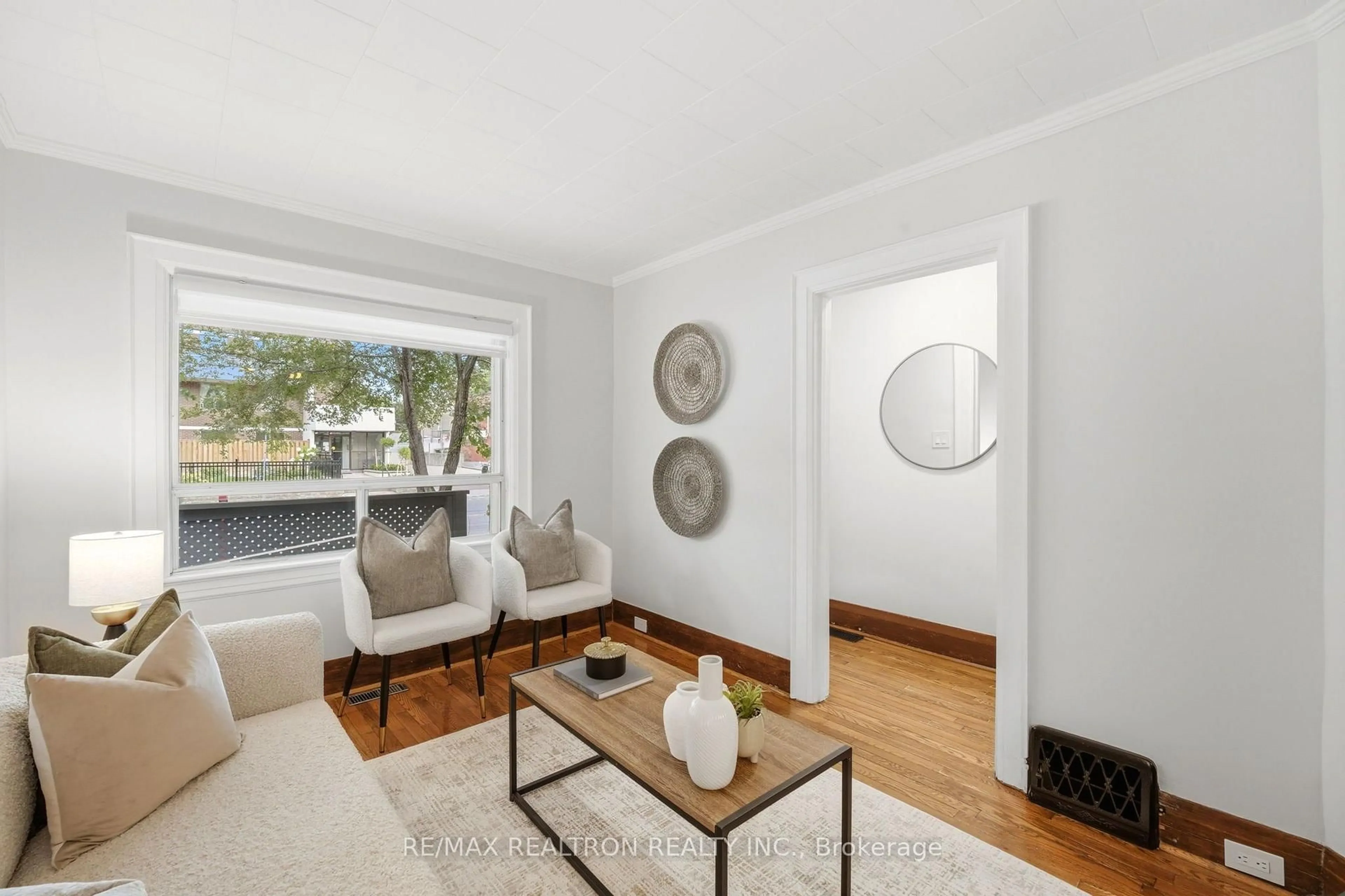 Living room with furniture, wood/laminate floor for 1056 Woodbine Ave, Toronto Ontario M4C 4C5