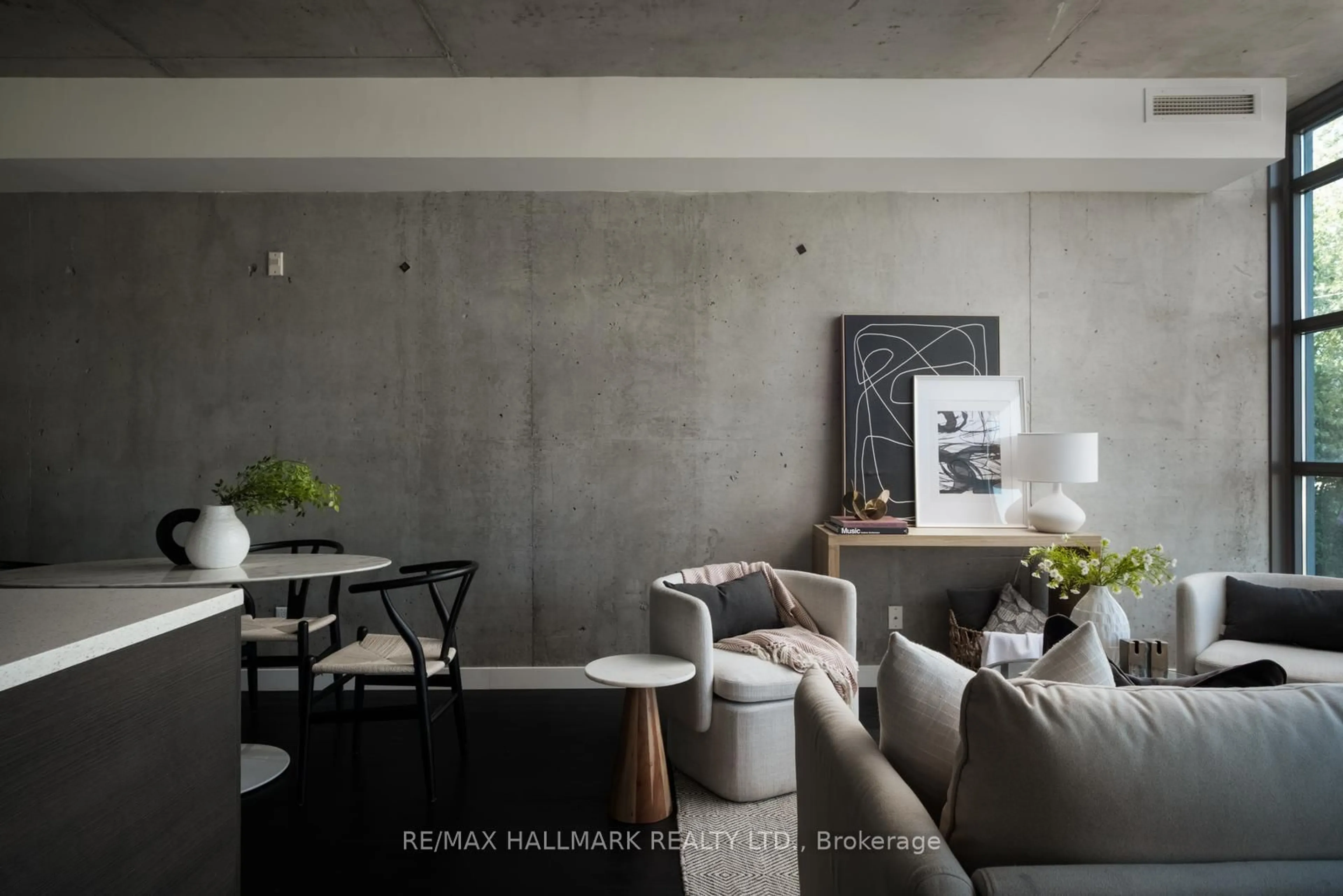 Living room with furniture, cement floor for 90 Broadview Ave #202, Toronto Ontario M4M 0A7
