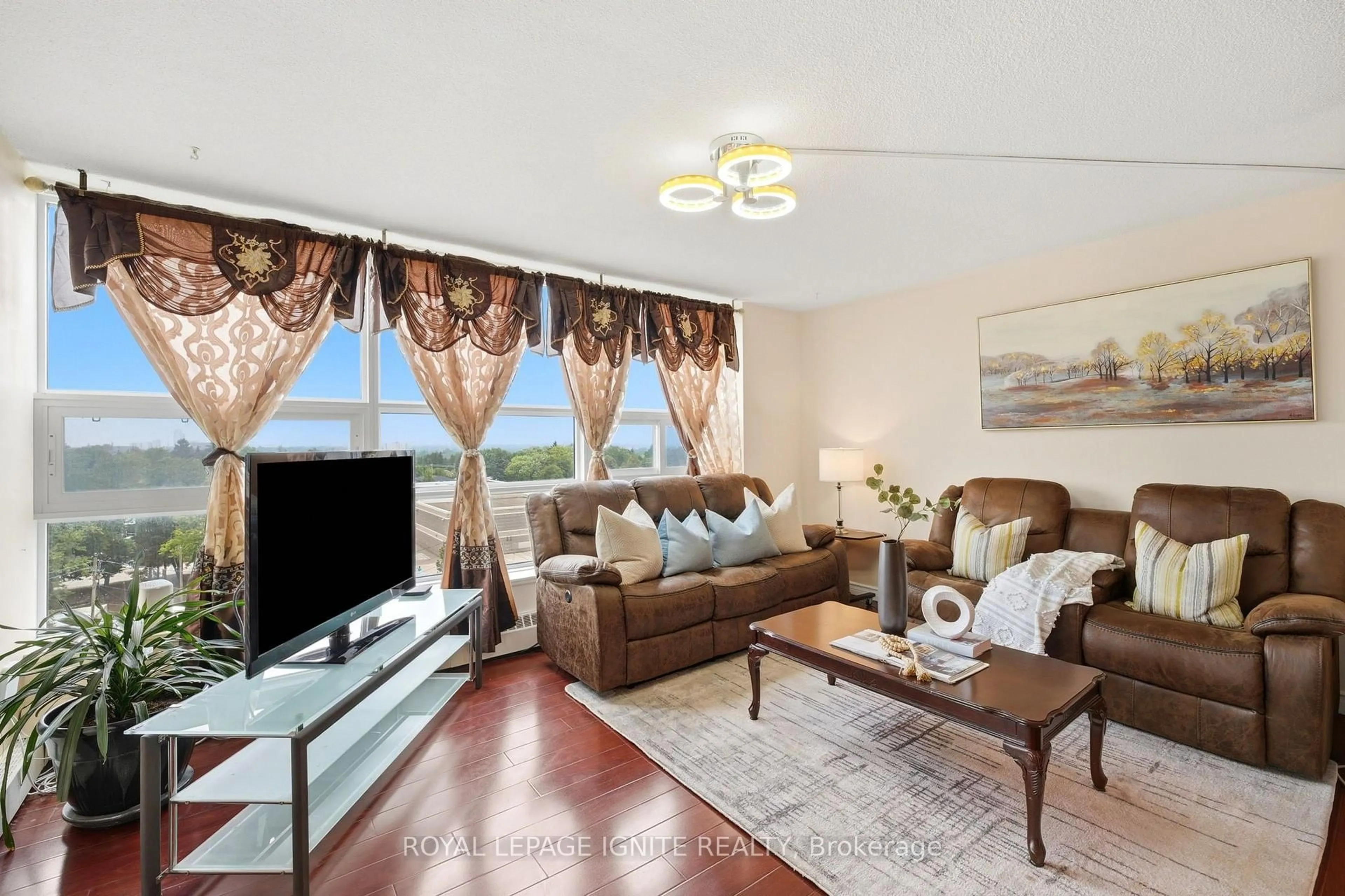 Living room with furniture, wood/laminate floor for 3380 Eglinton Ave #903, Toronto Ontario M1J 3L6