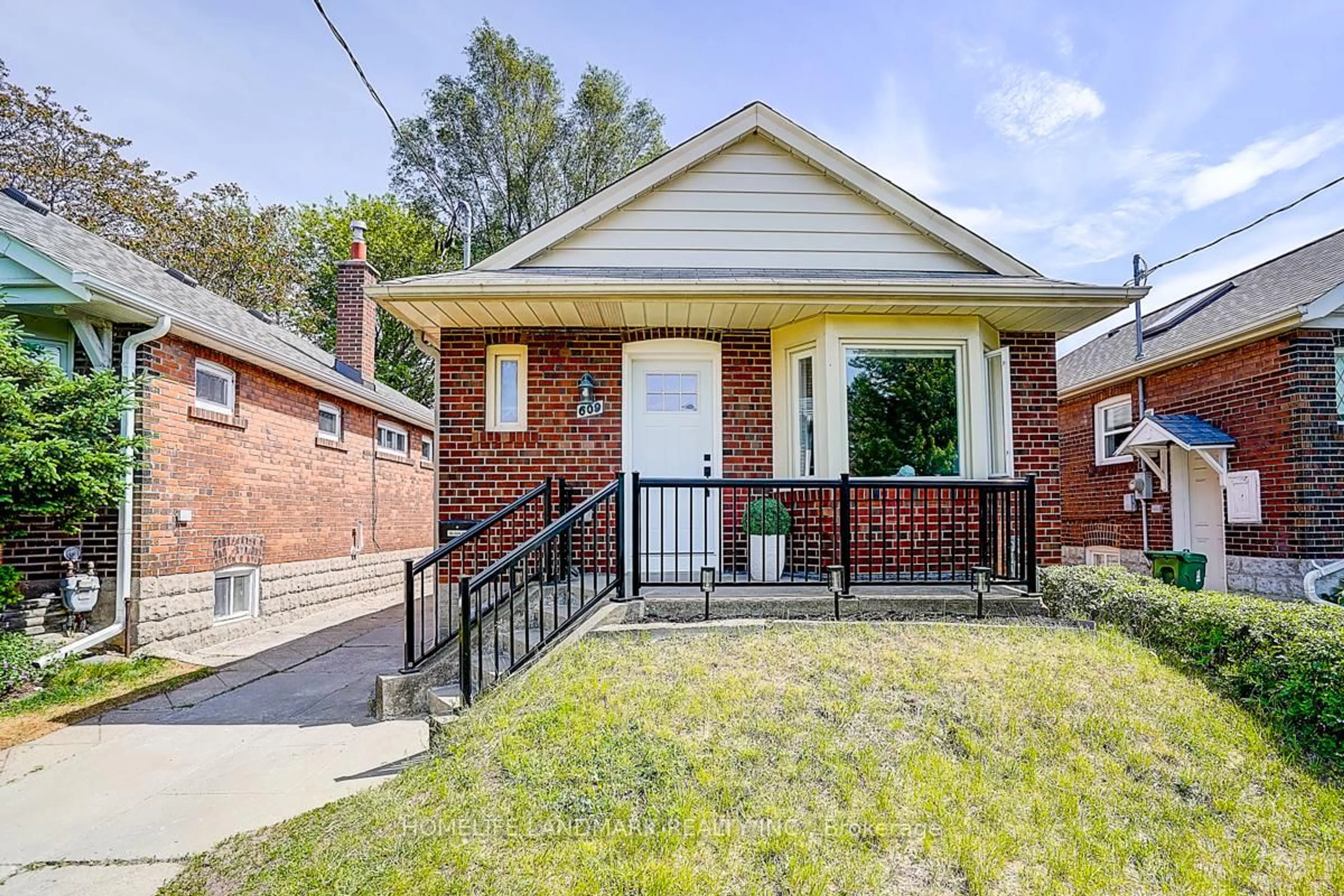 Home with brick exterior material, street for 609 Mortimer Ave, Toronto Ontario M4C 2J6