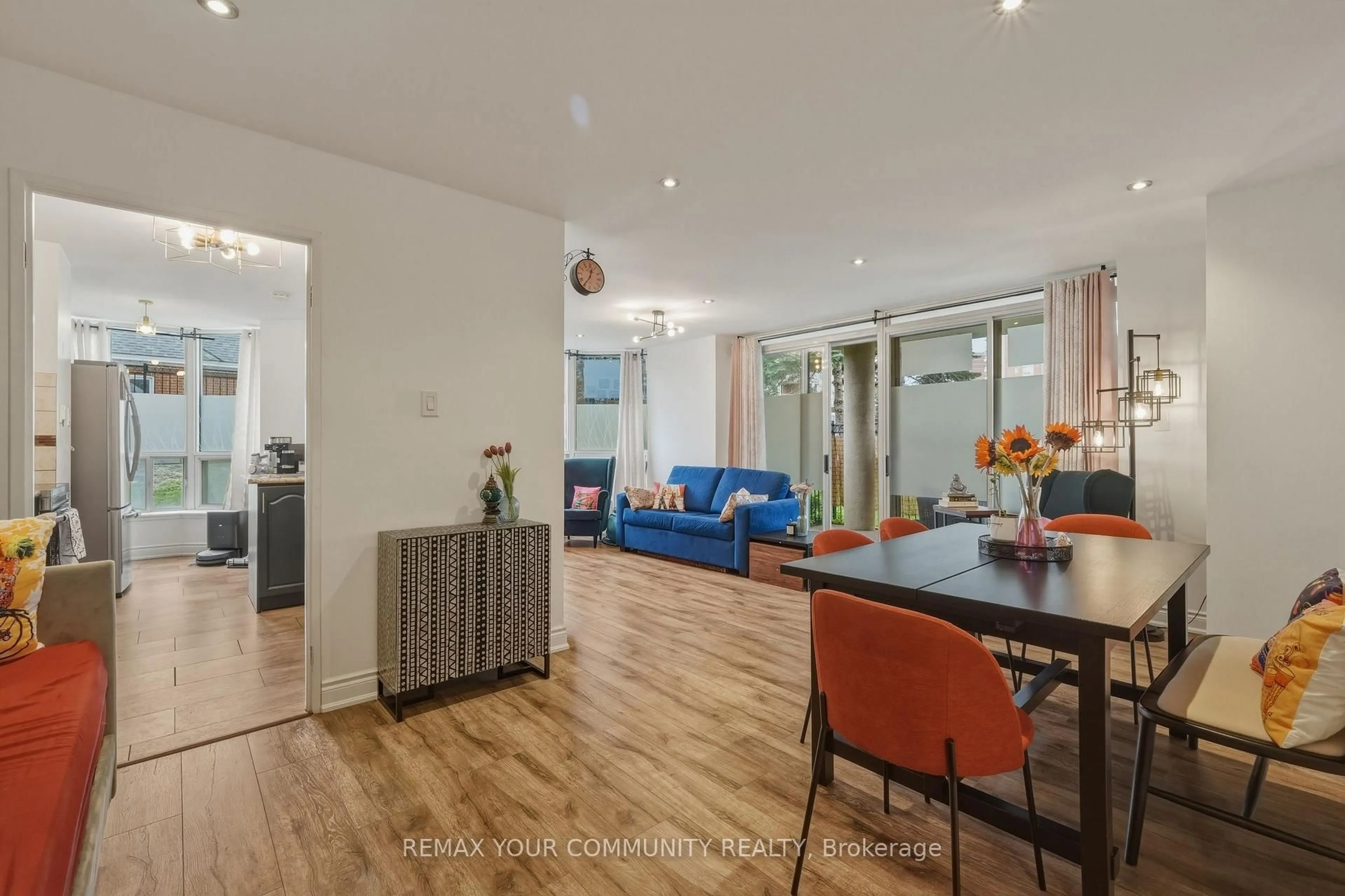 Living room with furniture, wood/laminate floor for 410 McLevin Ave #103, Toronto Ontario M1B 5J5