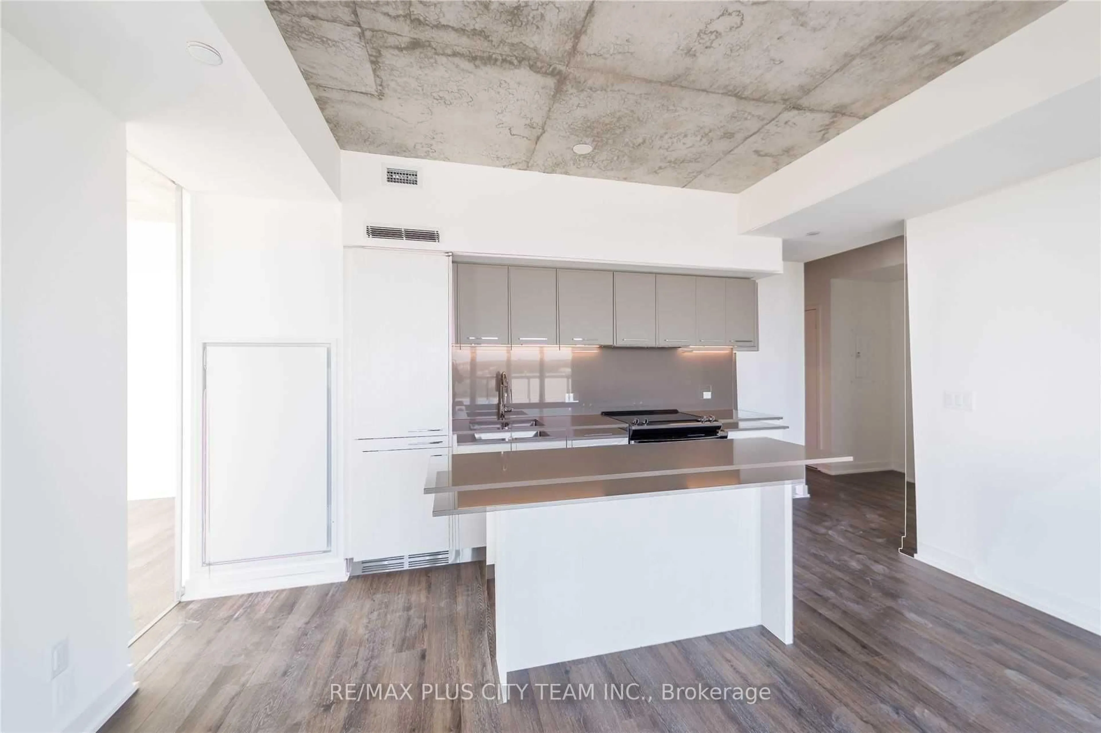 Open concept kitchen, cement floor for 15 Baseball Pl #1504, Toronto Ontario M4M 0E6
