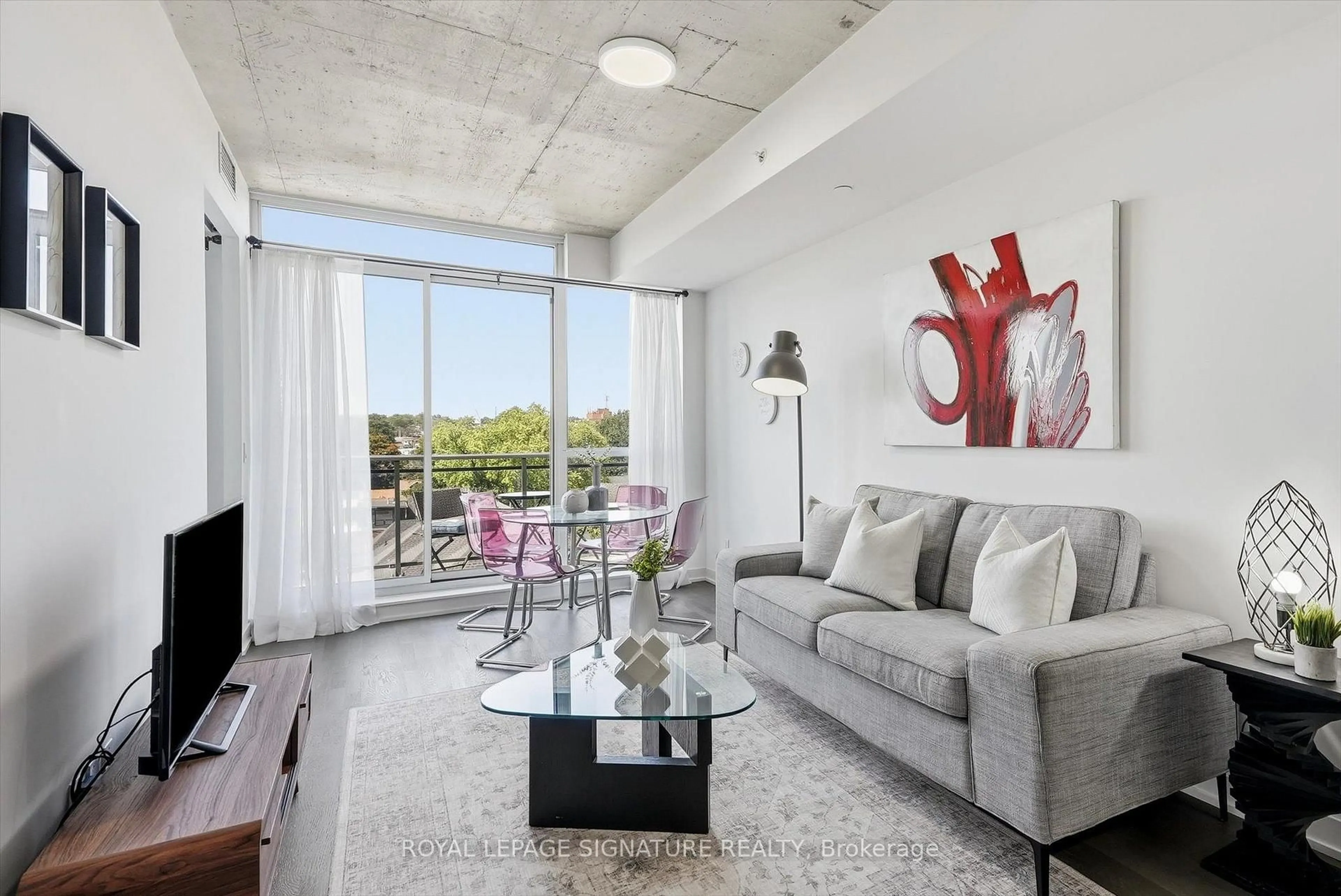 Living room with furniture, cement floor for 1238 Dundas St #711, Toronto Ontario M4M 0C6