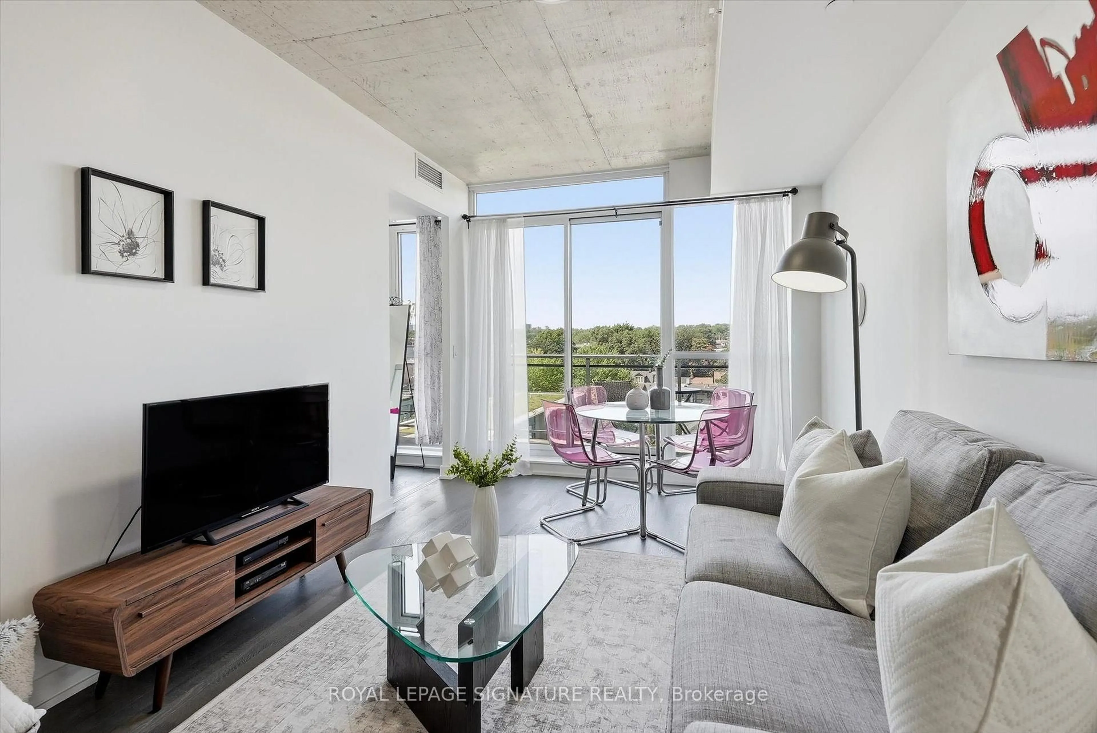 Living room with furniture, cement floor for 1238 Dundas St #711, Toronto Ontario M4M 0C6