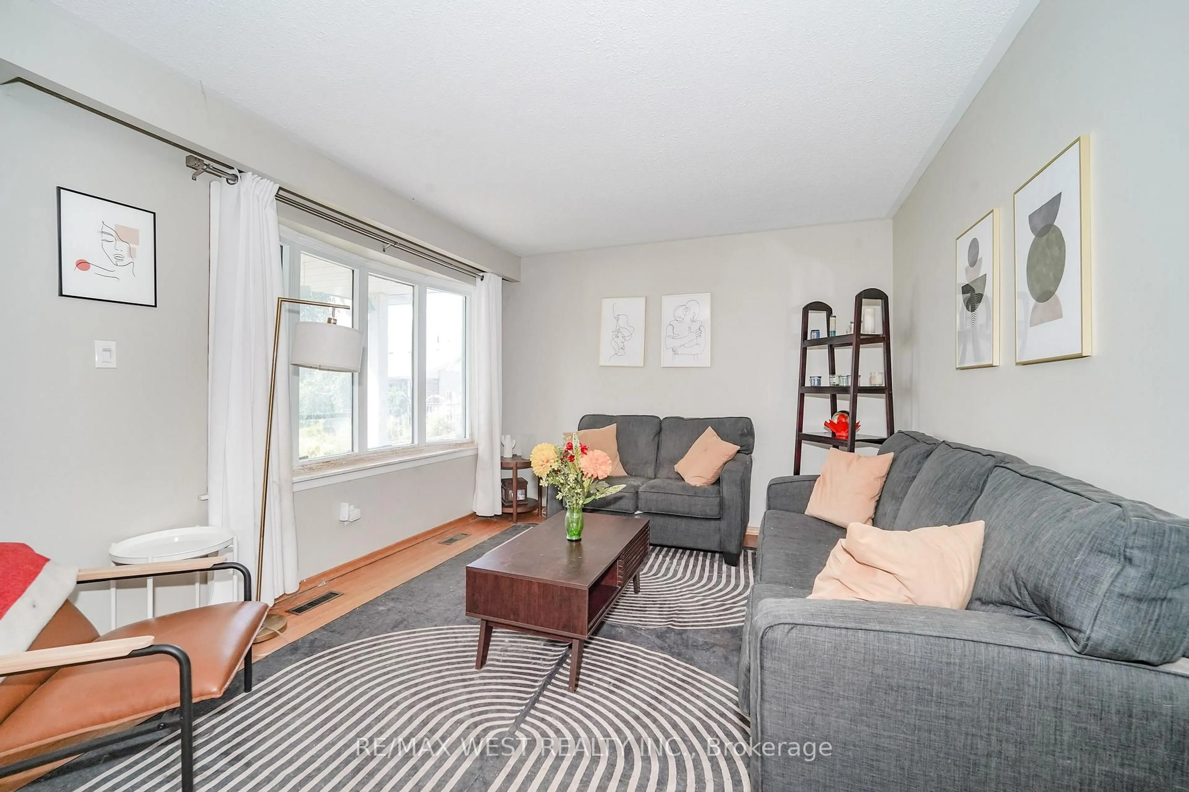 Living room with furniture, wood/laminate floor for 1105 Valley Crt, Oshawa Ontario L1J 3M4