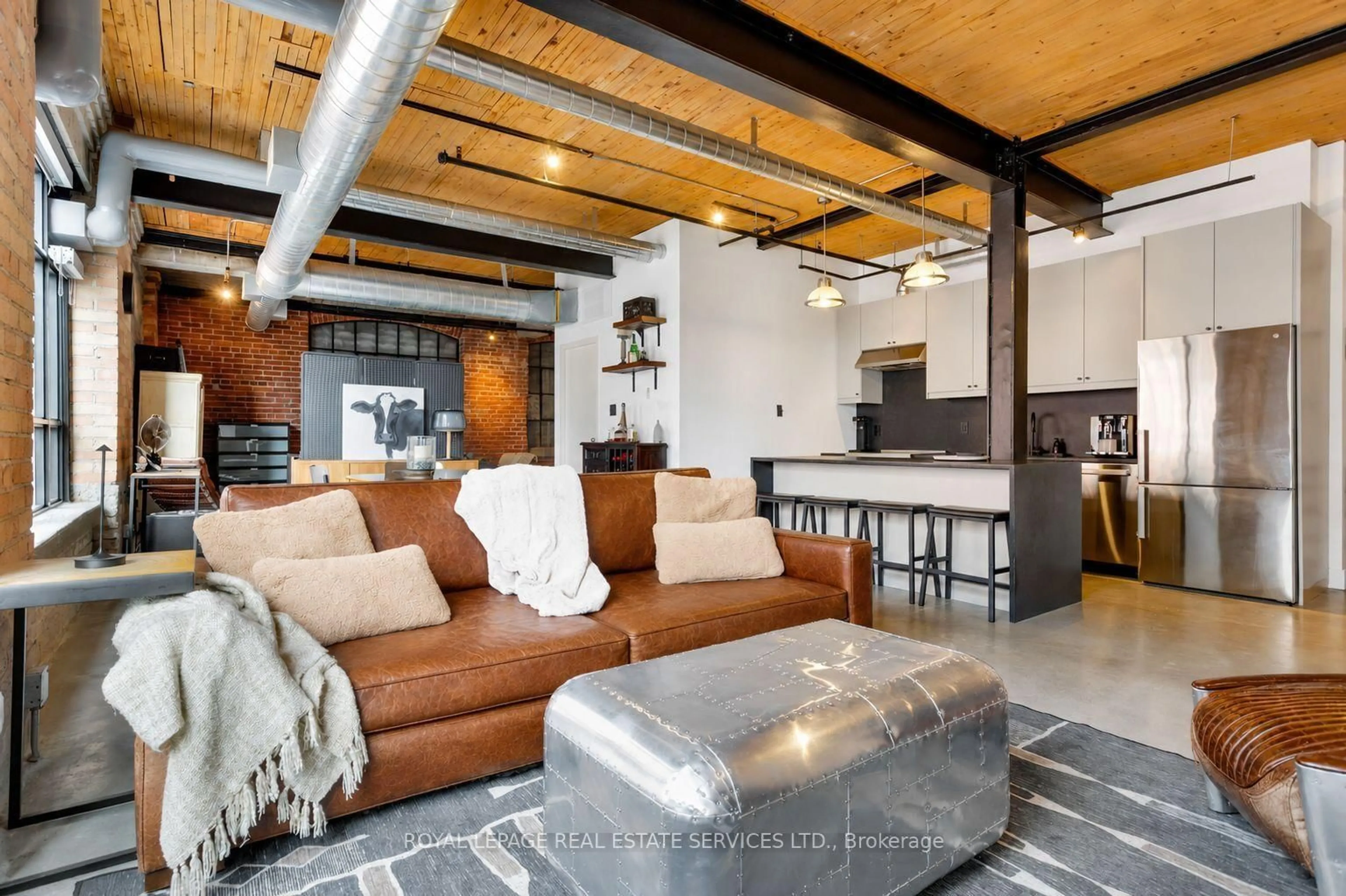 Living room with furniture, cement floor for 68 Broadview Ave #326, Toronto Ontario M4M 2E6